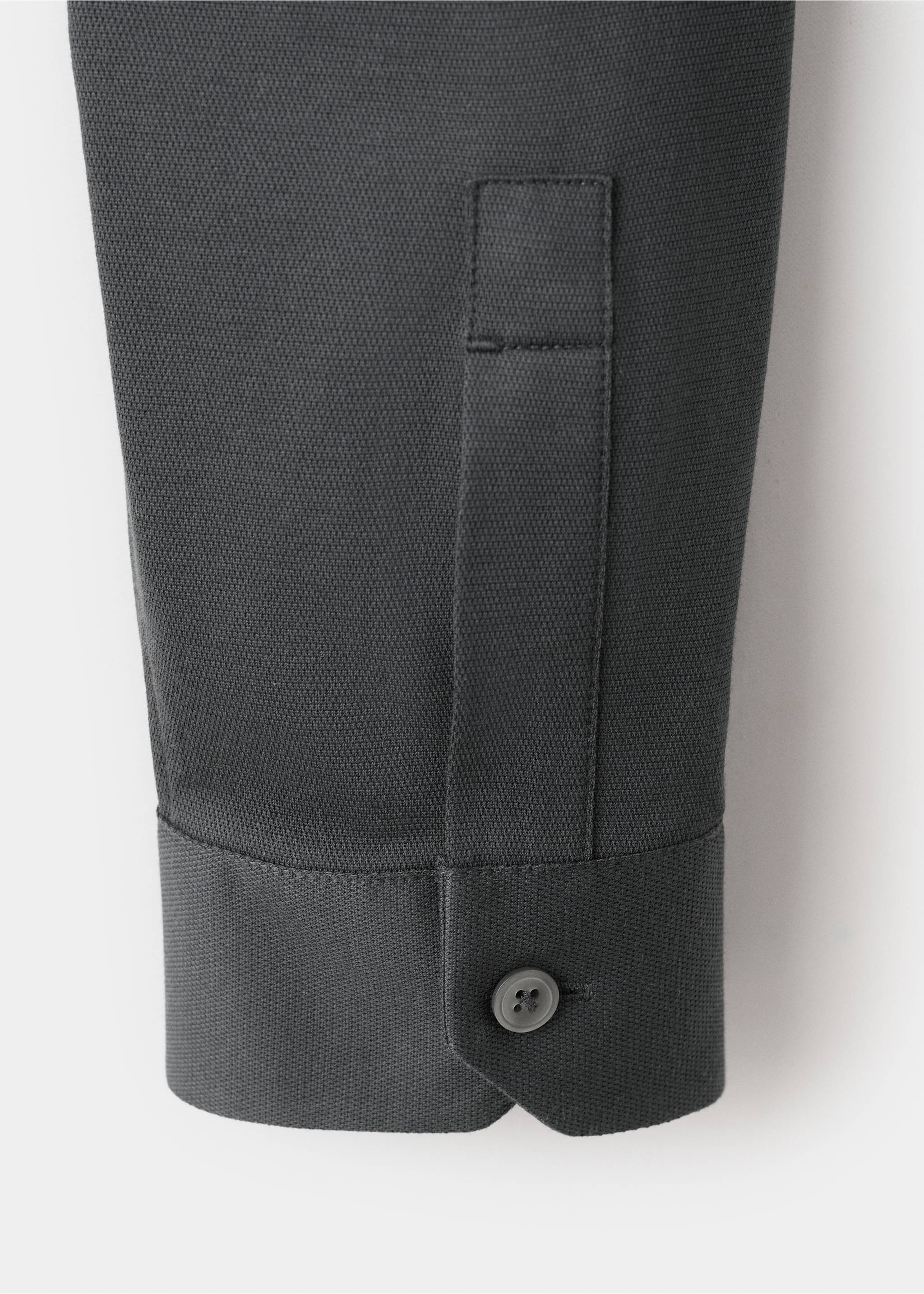 Close-up of a dark grey shirt sleeve showing the textured fabric and buttoned cuff., Charcoal. Ref: 27054422-00.