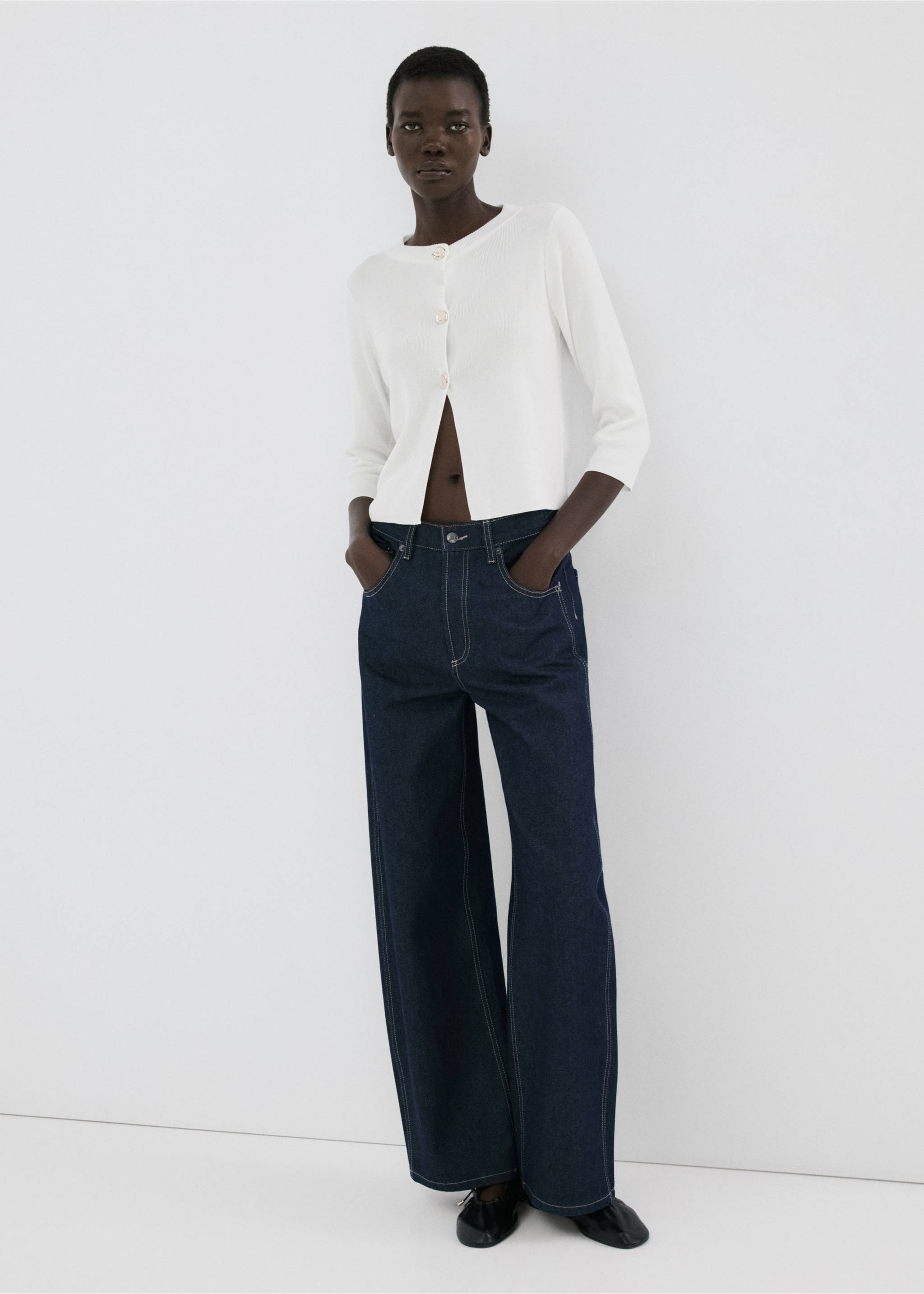 White cardigan with three-quarter length sleeves and decorative buttons, worn with dark denim trousers., Ecru. Ref: 27055822-00.