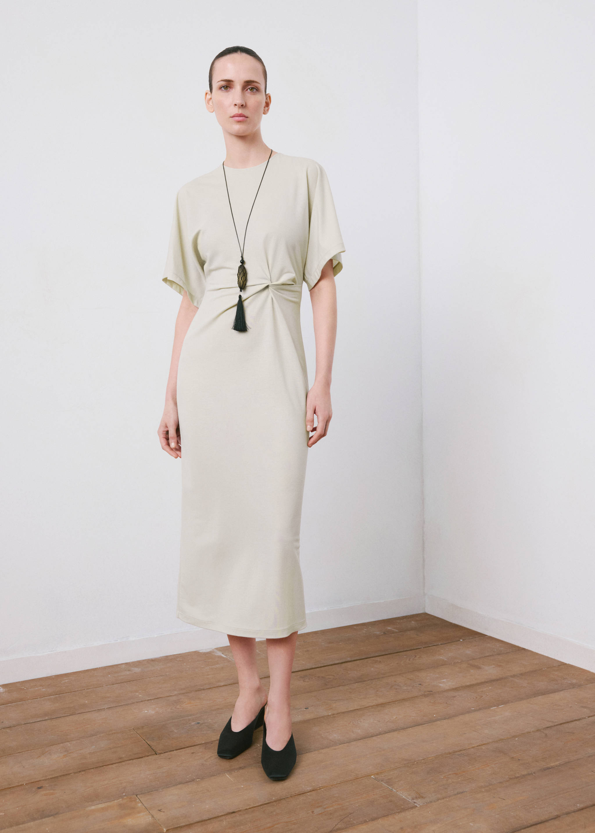 Light sage green midi dress with short sleeves and waist knot detail.