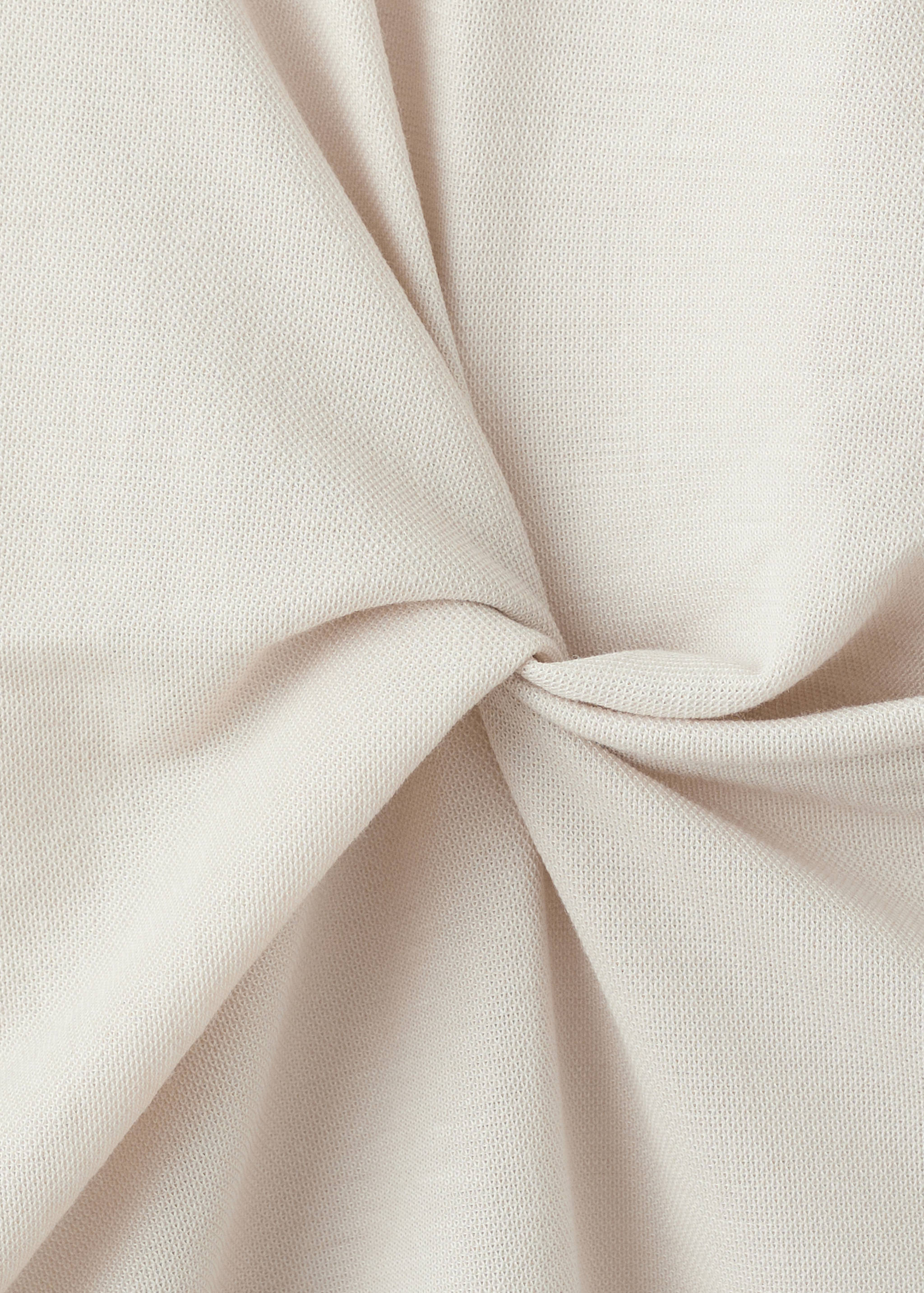 Close-up of the beige dress fabric texture.