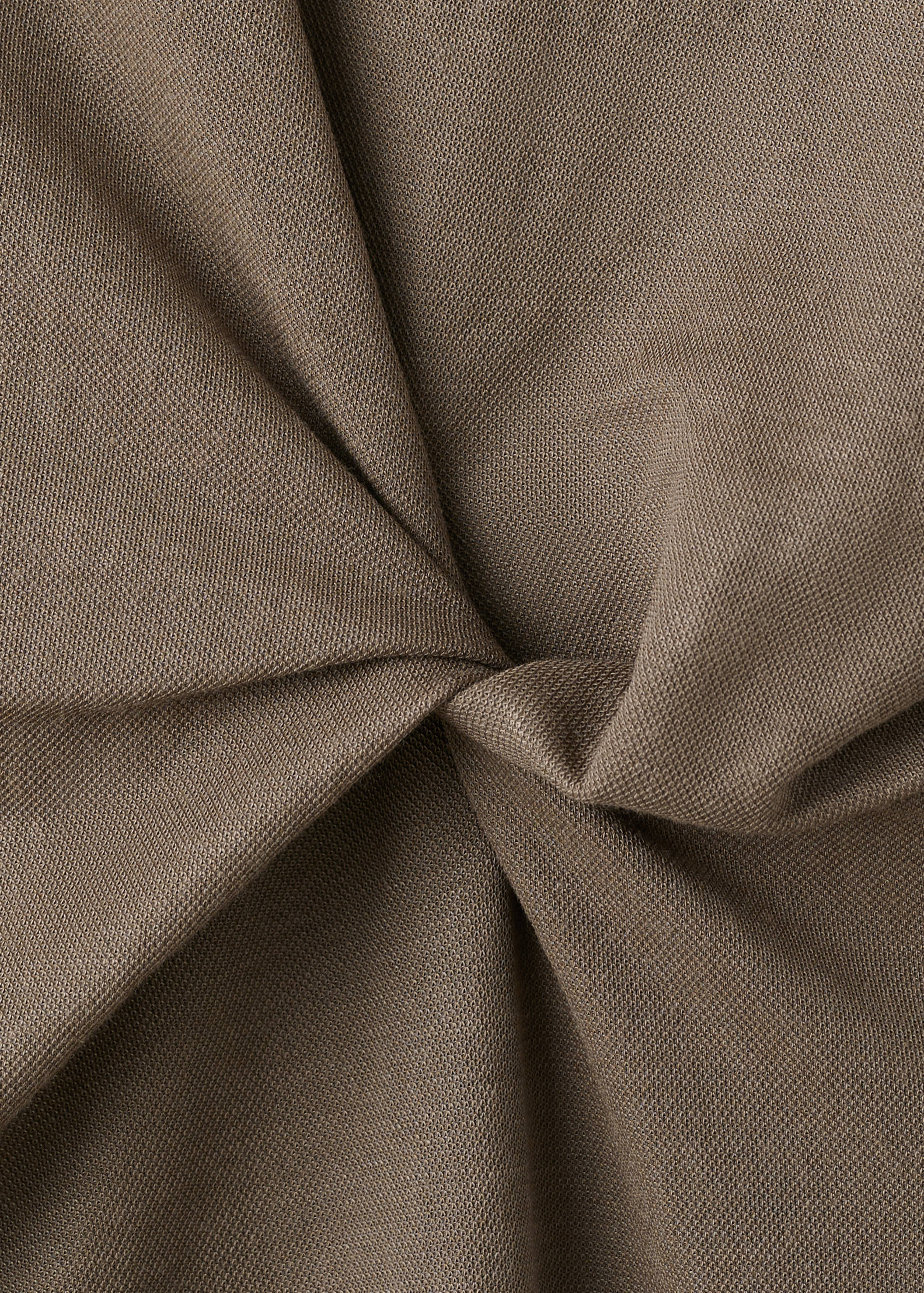 Brown dress fabric texture detail showing a gathered twist.