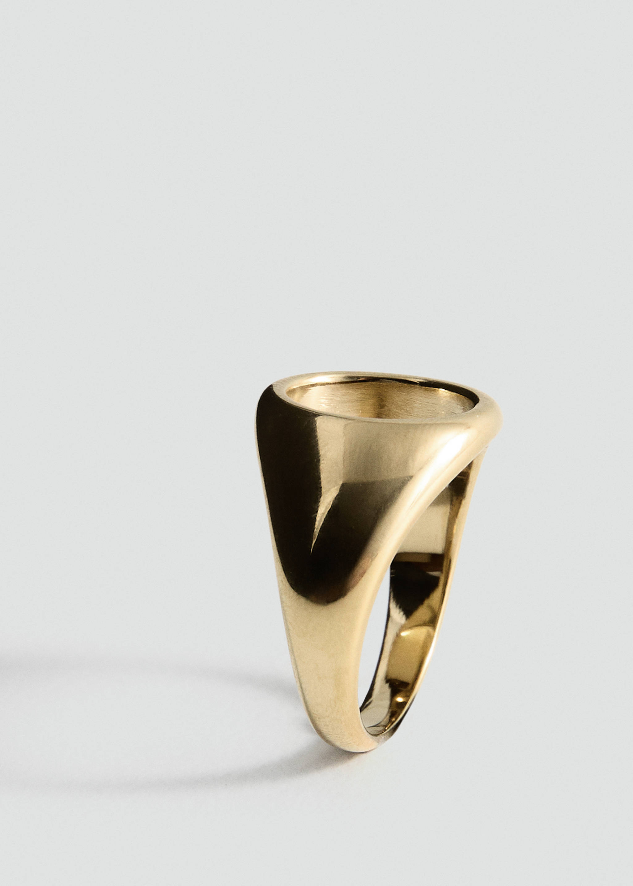 Polished gold-coloured signet ring in a three-quarter view.