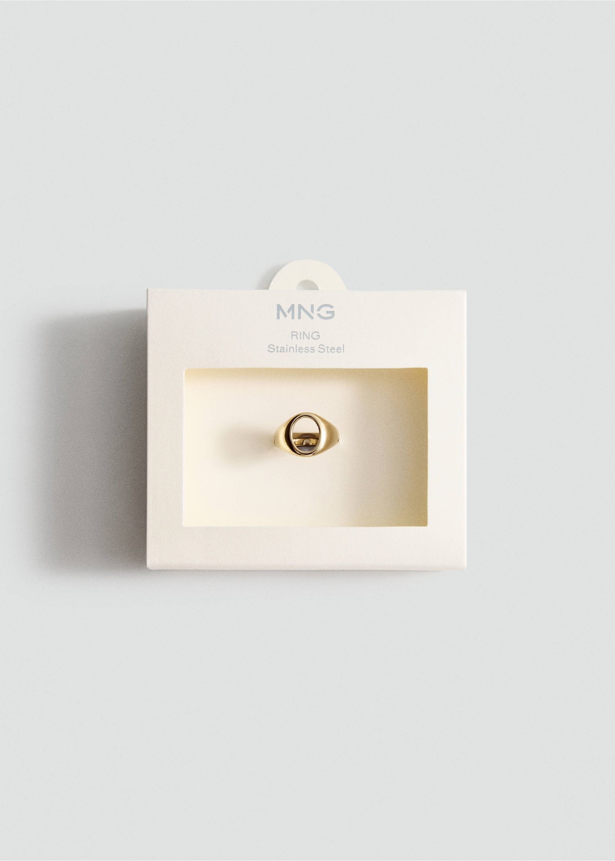 Gold-coloured stainless steel ring with a cutout geometric design in its packaging., Gold. Ref: 27055976-00.
