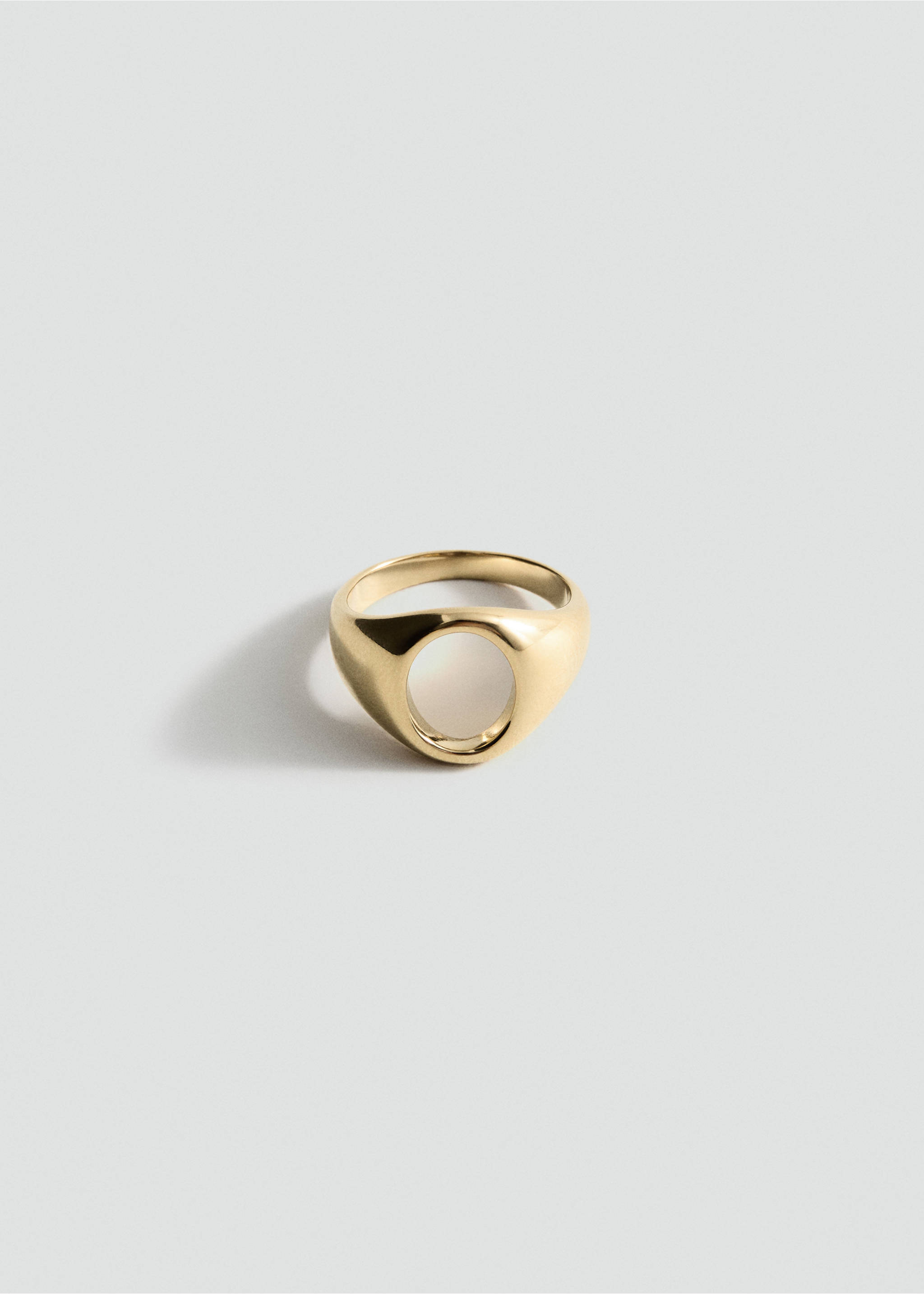 Gold-tone metal ring with a chunky band and a circular cut-out detail., Gold. Ref: 27055976-00.
