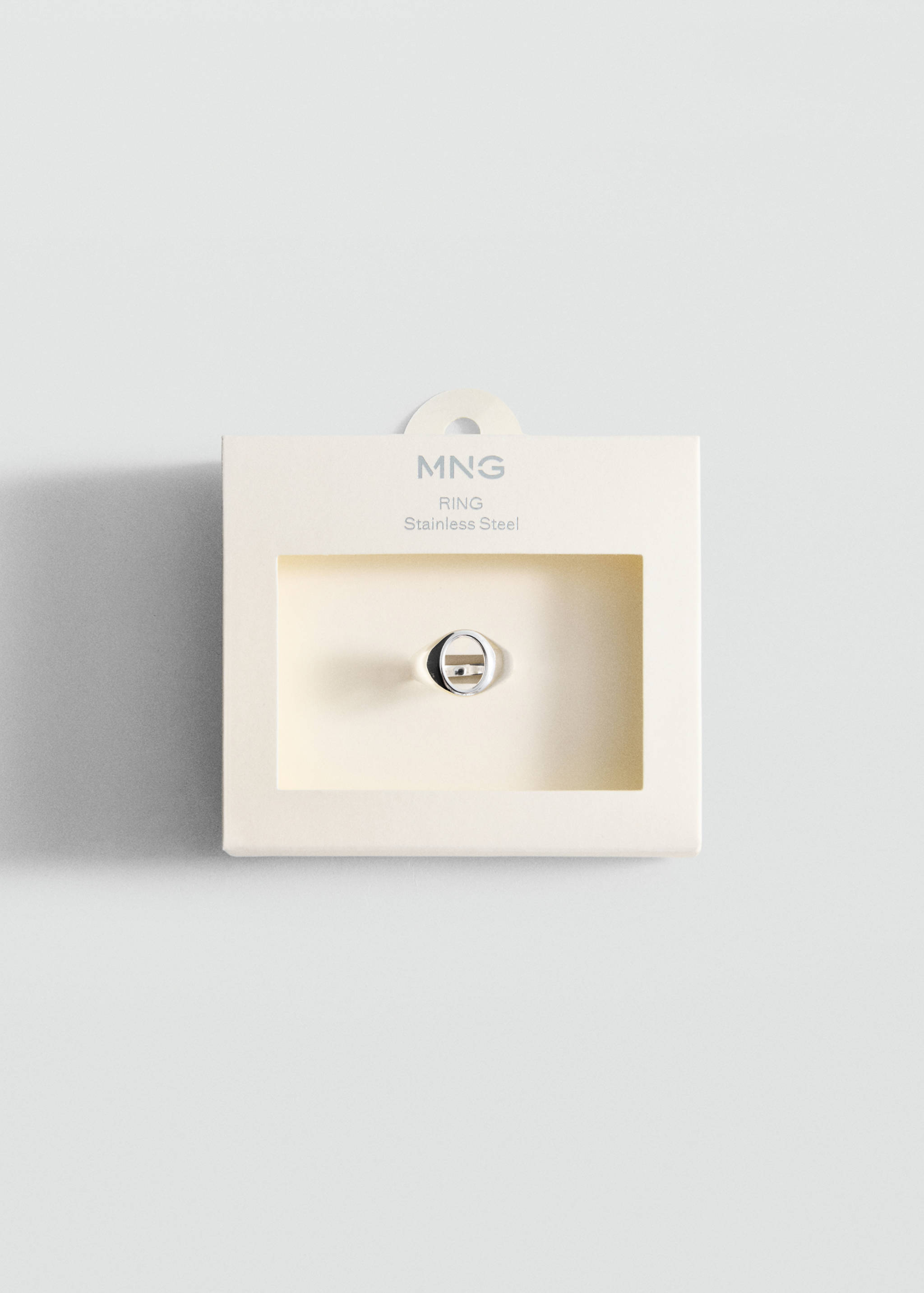 Silver-coloured stainless steel ring in a beige presentation box.