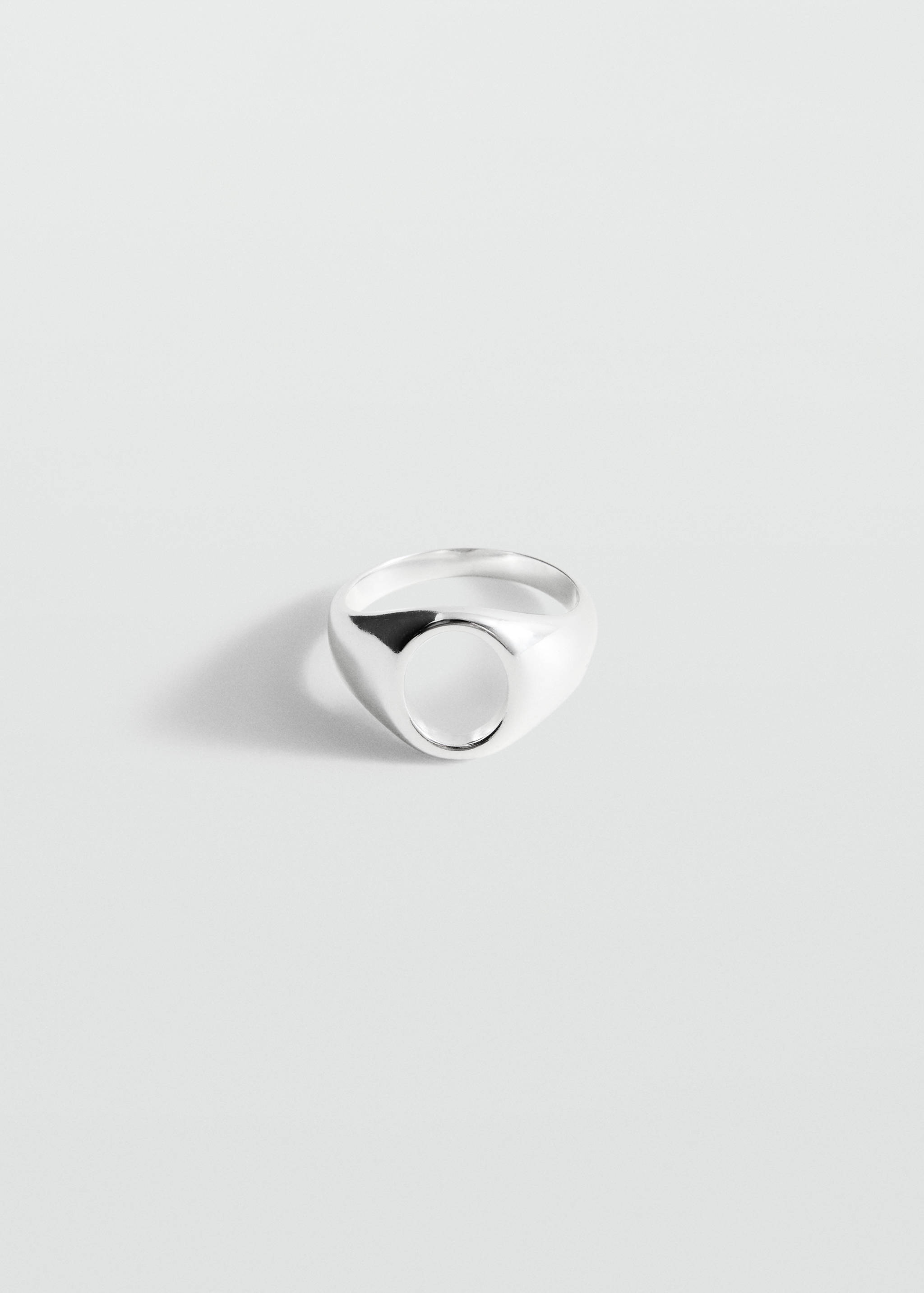 Polished silver-coloured signet ring in still-life view.