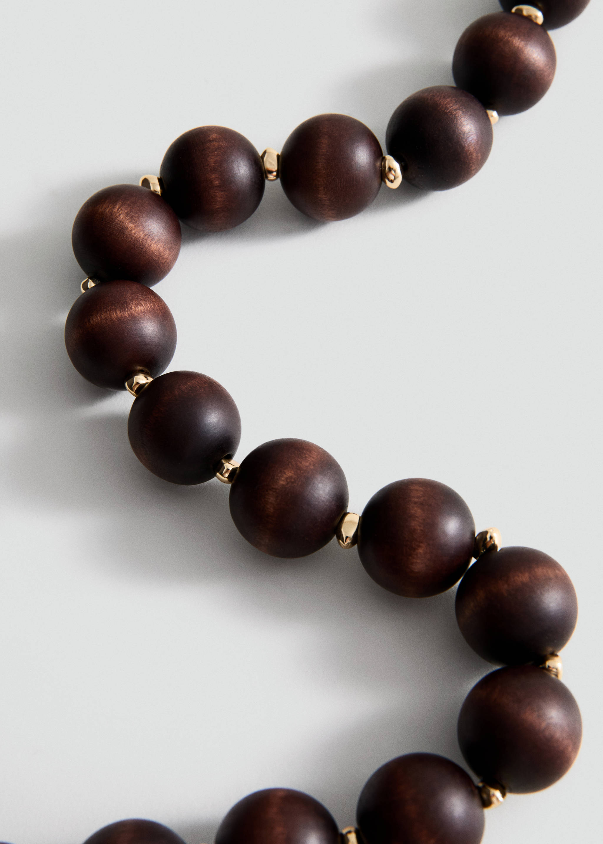 Dark brown wooden bead collar with gold-toned metal spacers.