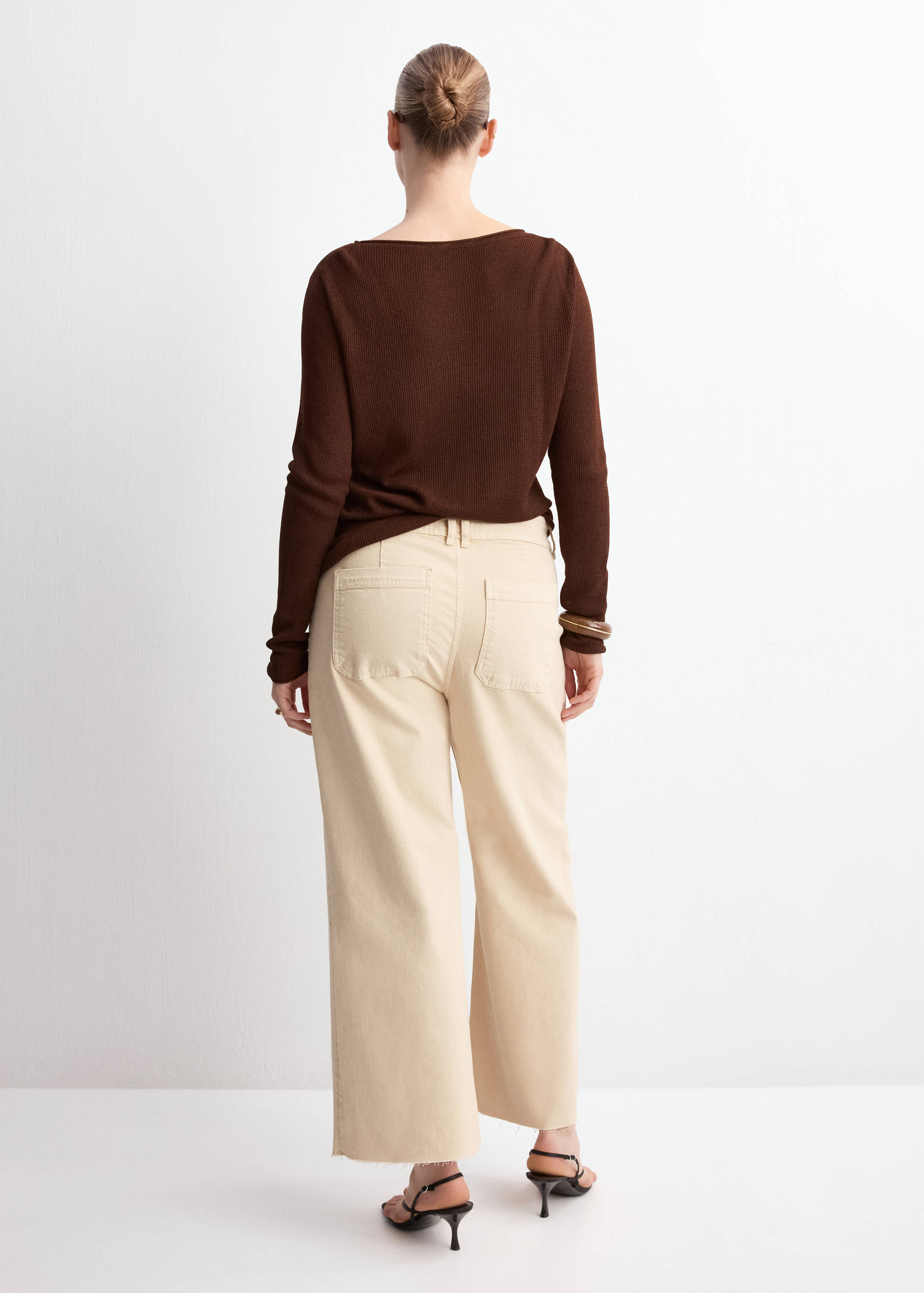 Cream denim trousers in a wide-leg fit, shown from the back.