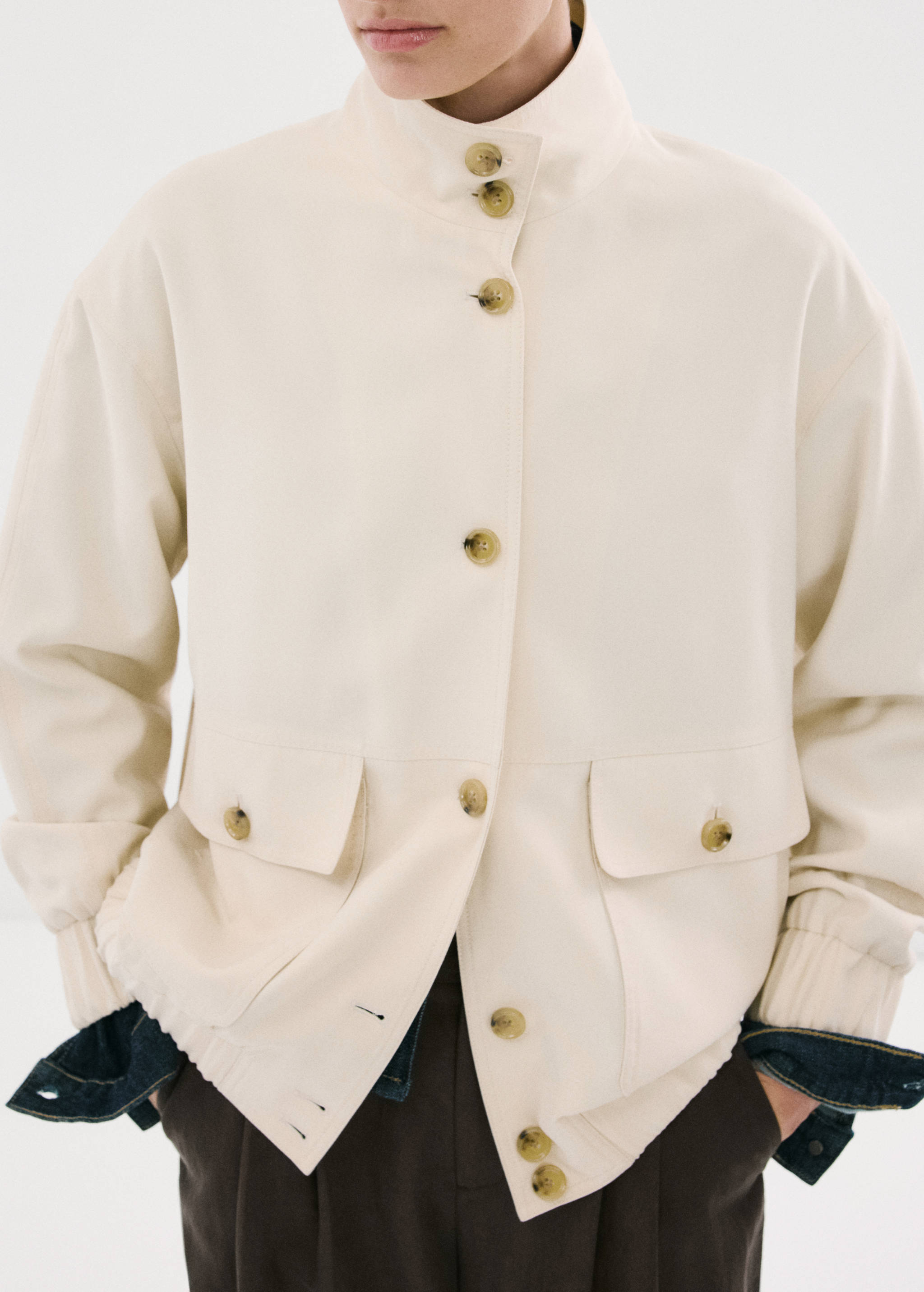Chaqueta blanca rota de cuello alto y botones efecto carey.