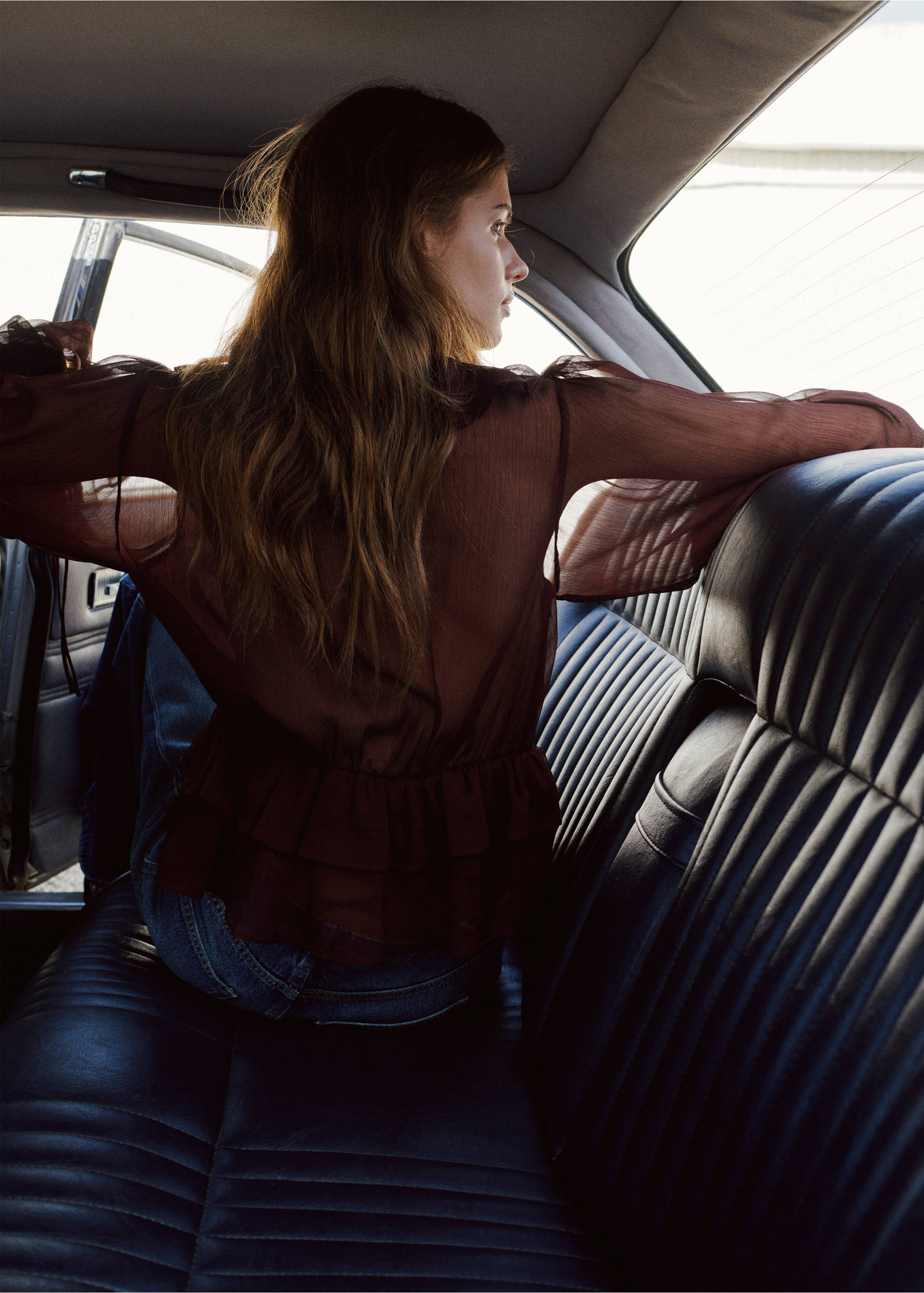 Sheer dark brown blouse with long sleeves and a tiered ruffled hem, shown from behind., Chocolate. Ref: 27067160-00.
