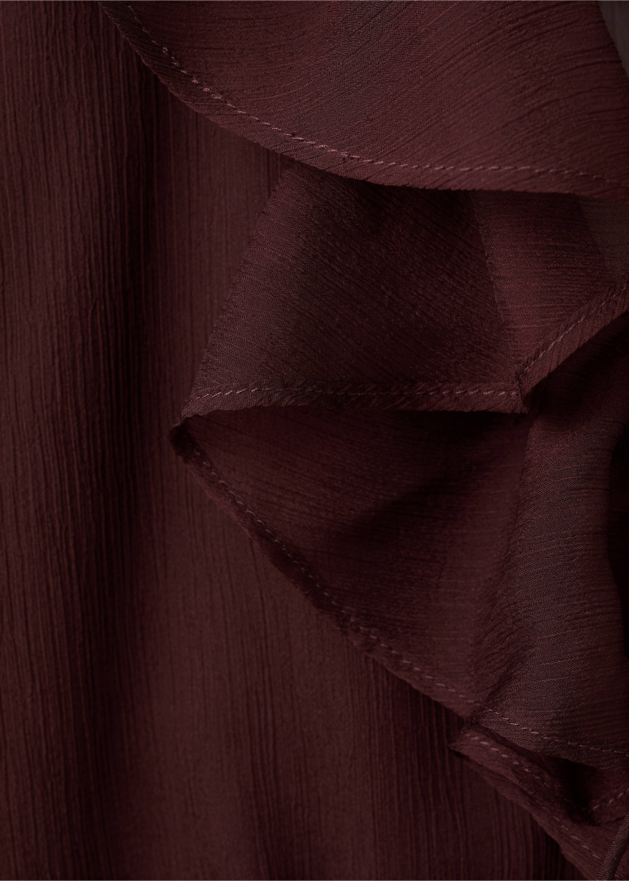 Close-up of a dark burgundy blouse detail showing the ruffled collar texture., Chocolate. Ref: 27067160-00.