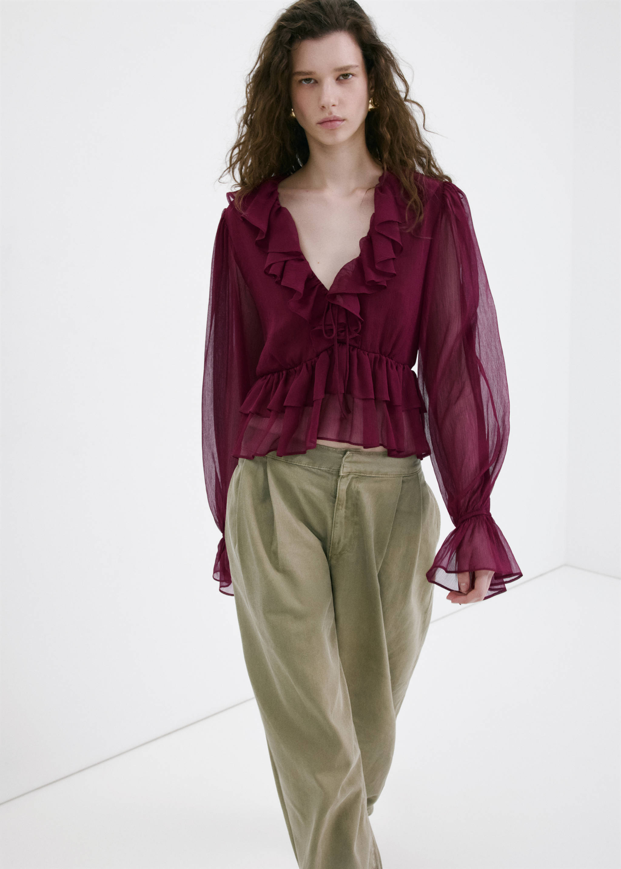 Burgundy sheer ruffle blouse with long sleeves and olive green trousers