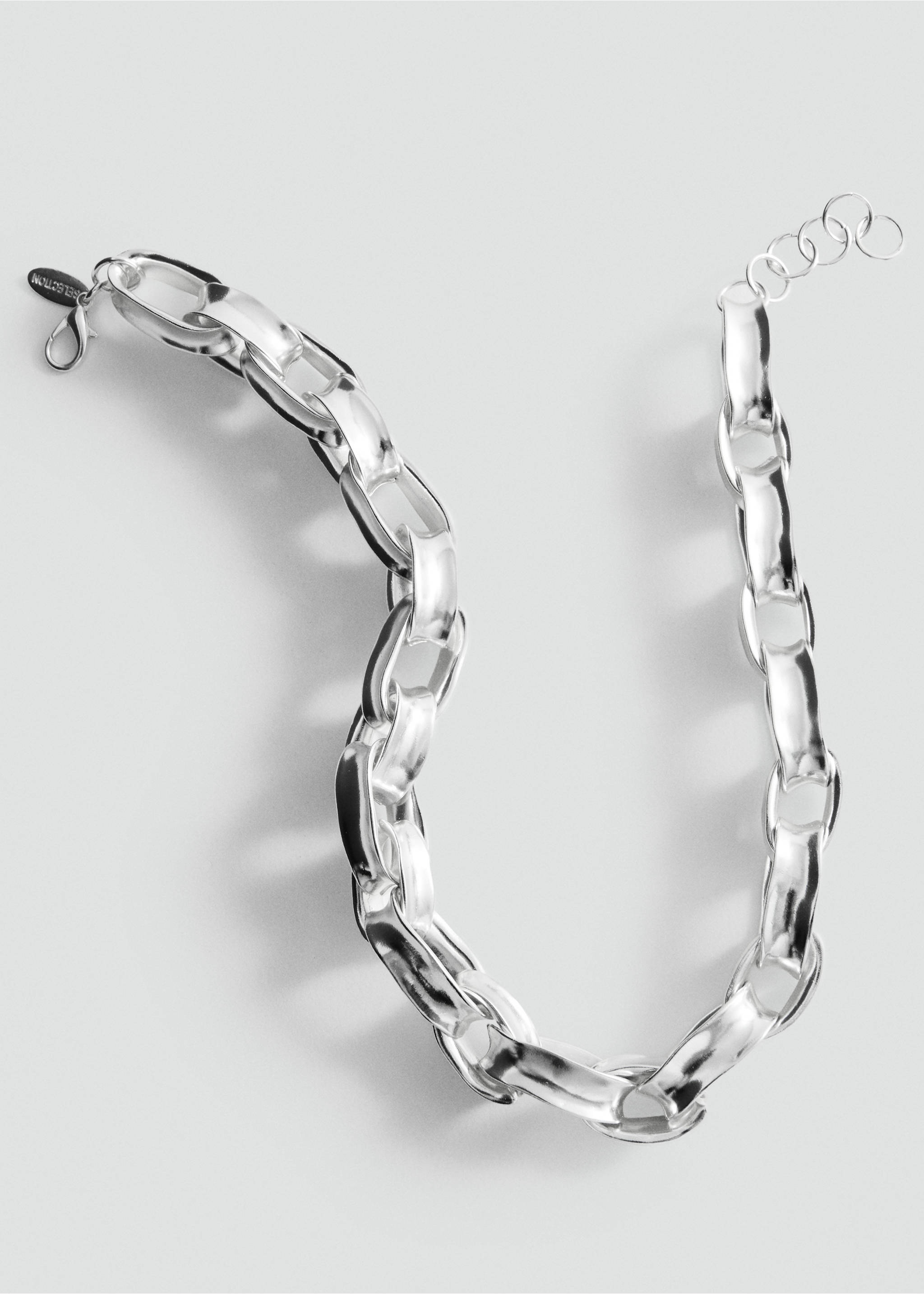 Close-up of a chunky silver-tone metallic chain necklace., Silver. Ref: 27067797-00.