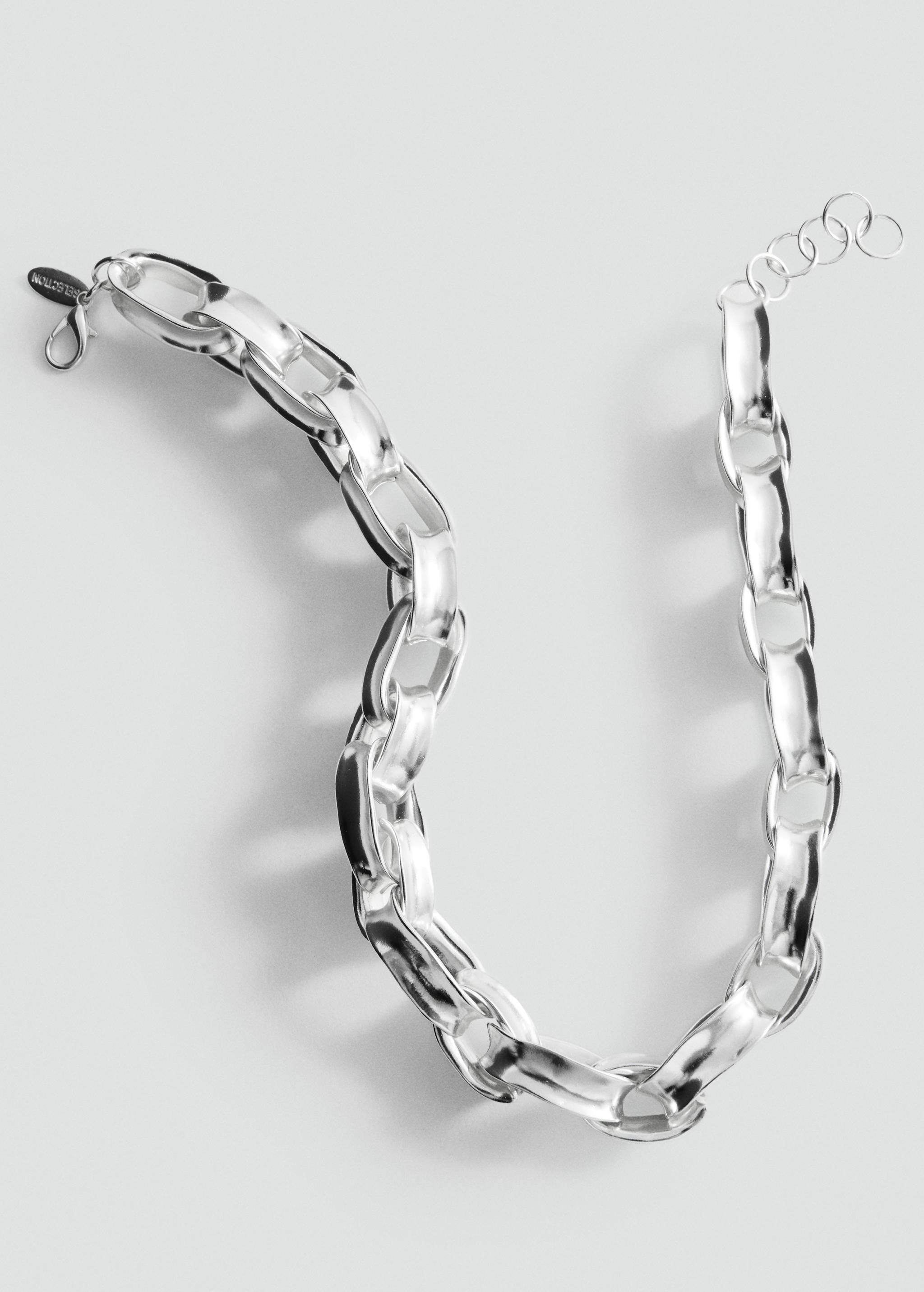 Close-up of a chunky silver-tone metallic chain necklace.