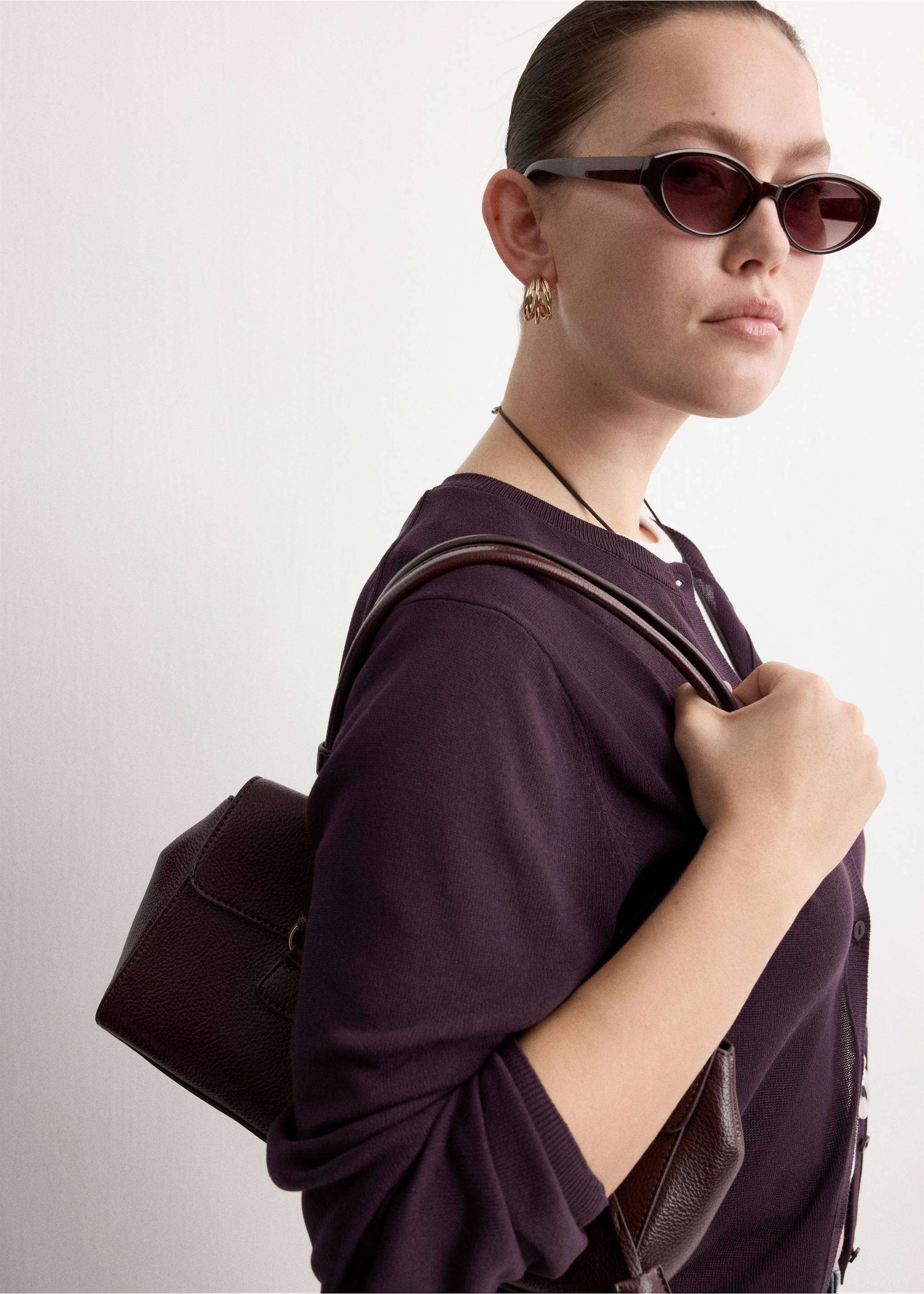 Plum purple button-down cardigan with a round neckline, worn with sunglasses and a shoulder bag., Wine. Ref: 27075819-00.