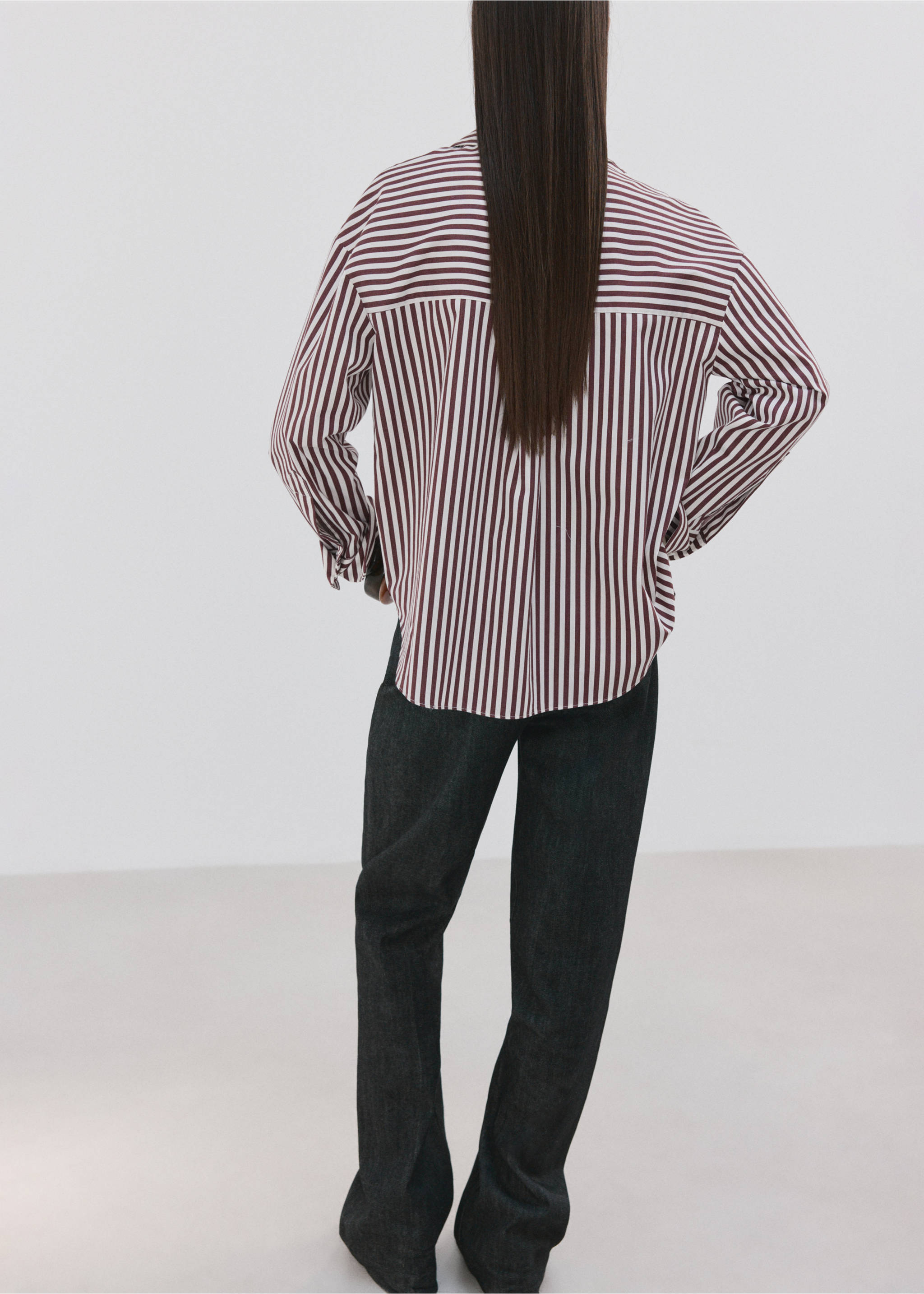 Burgundy and white striped oversized shirt seen from the back, paired with dark trousers., Ecru. Ref: 27075821-00.