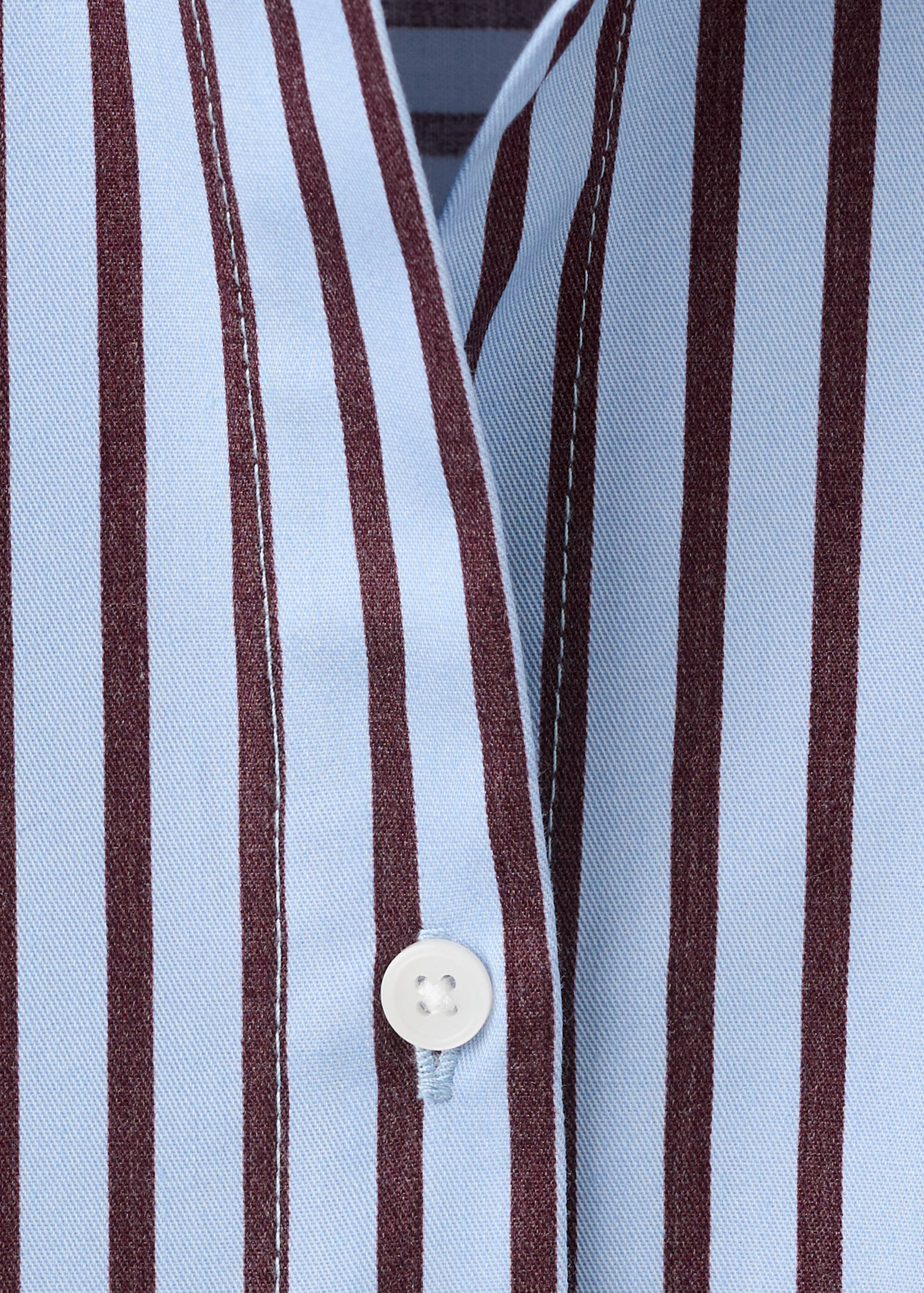 Close-up of a blue and dark brown striped shirt button placket.