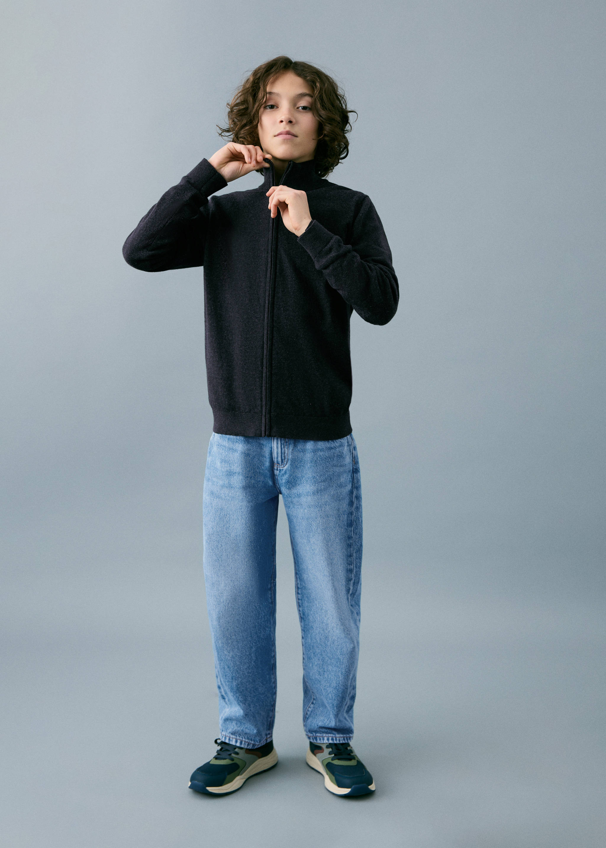 Dark grey knitted zip-up cardigan with high neck.