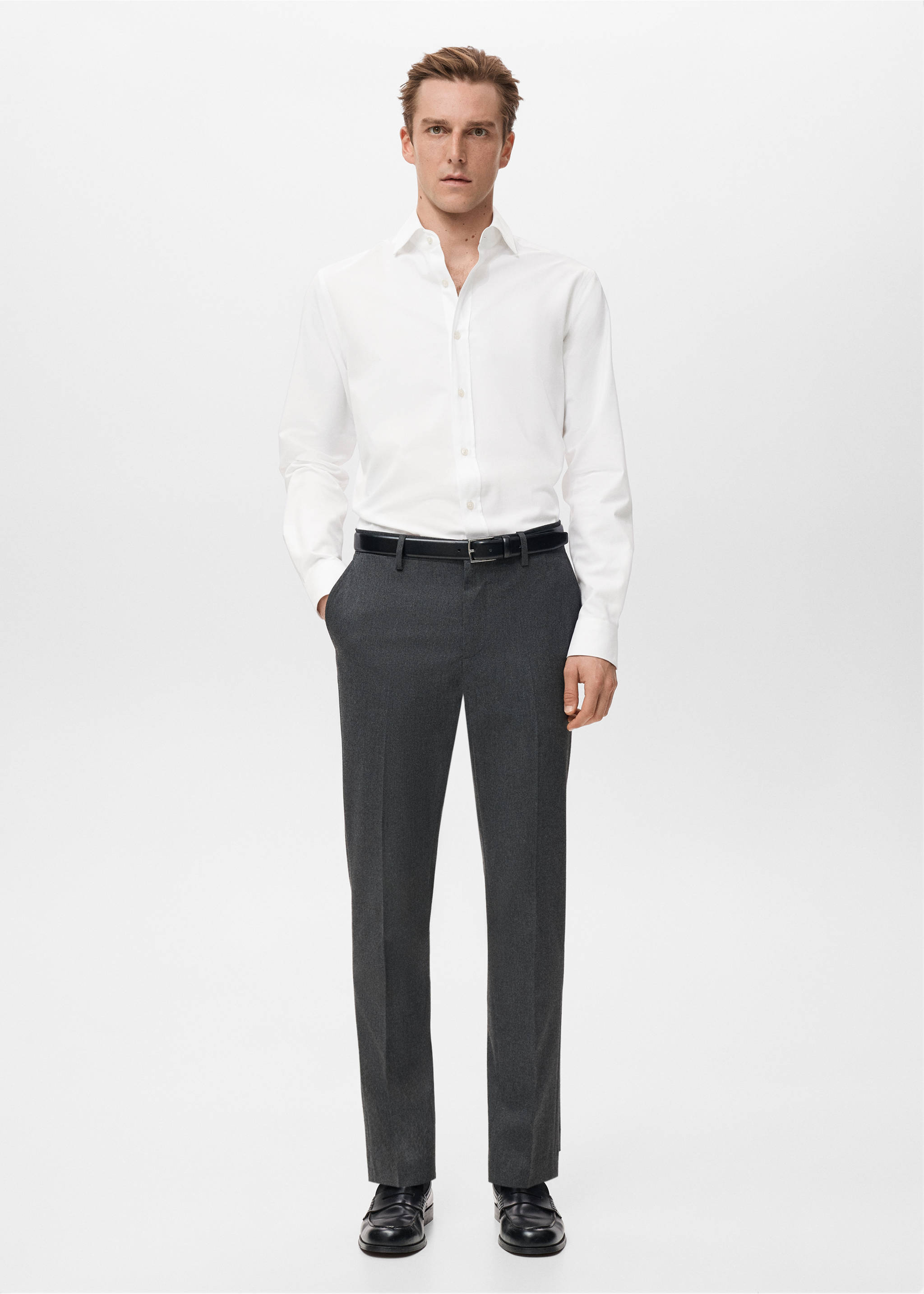 White long-sleeved shirt with a classic collar and front button fastening, worn with grey trousers., White. Ref: 27081310-00.