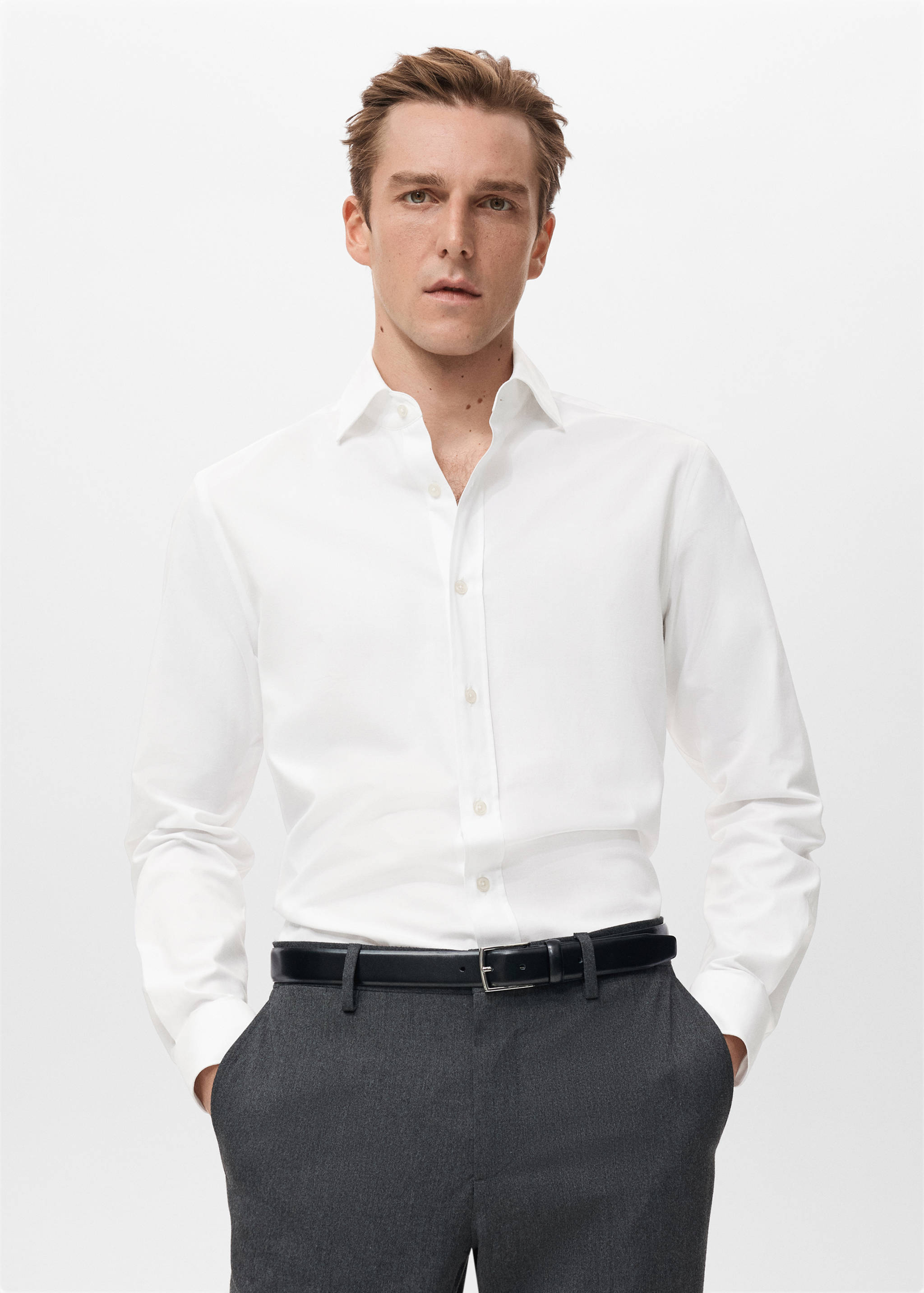 White long-sleeved shirt with a button-up front and classic collar.