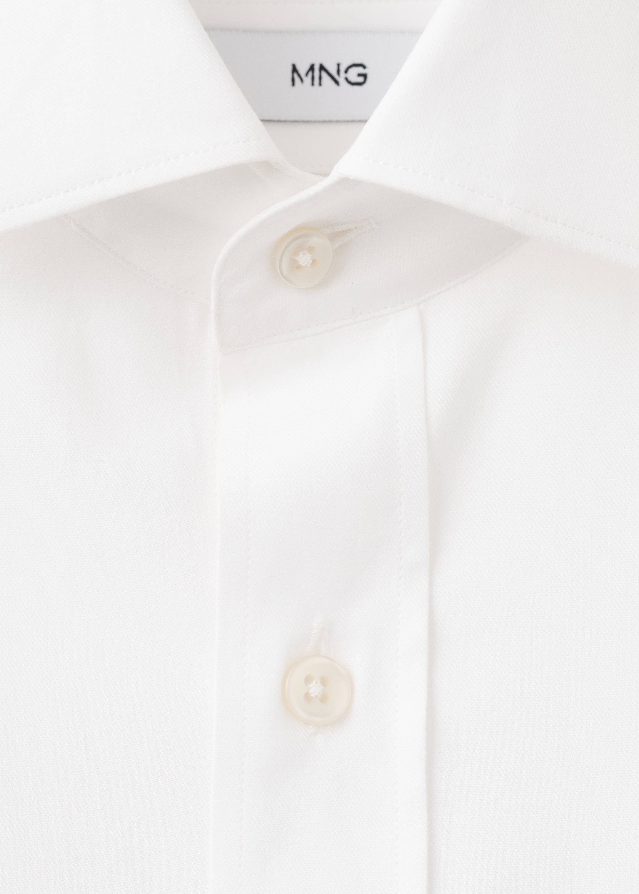 Close-up of a white shirt collar and button placket.