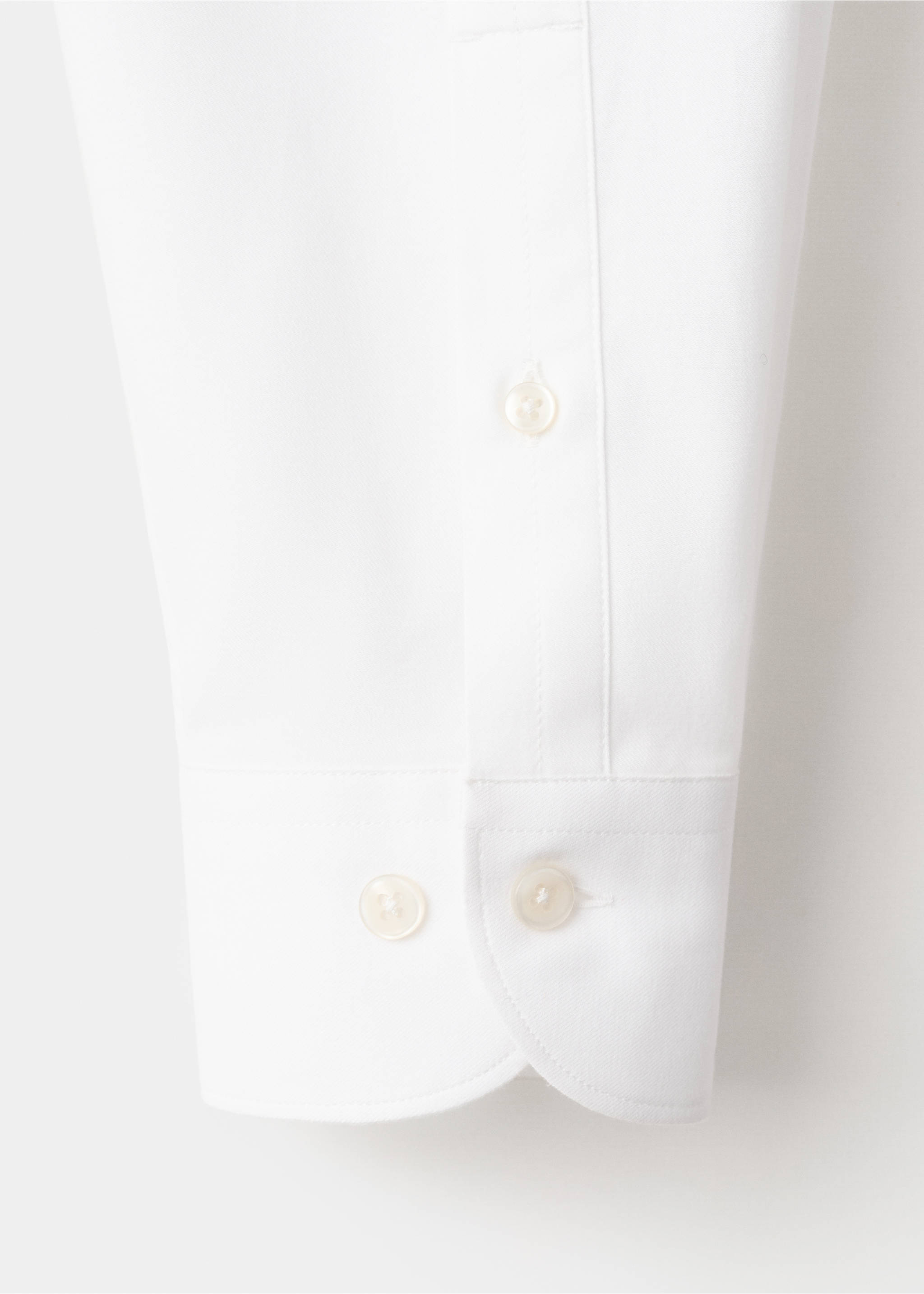 Close-up of white shirt fabric and buttoned cuff detail., White. Ref: 27081310-00.
