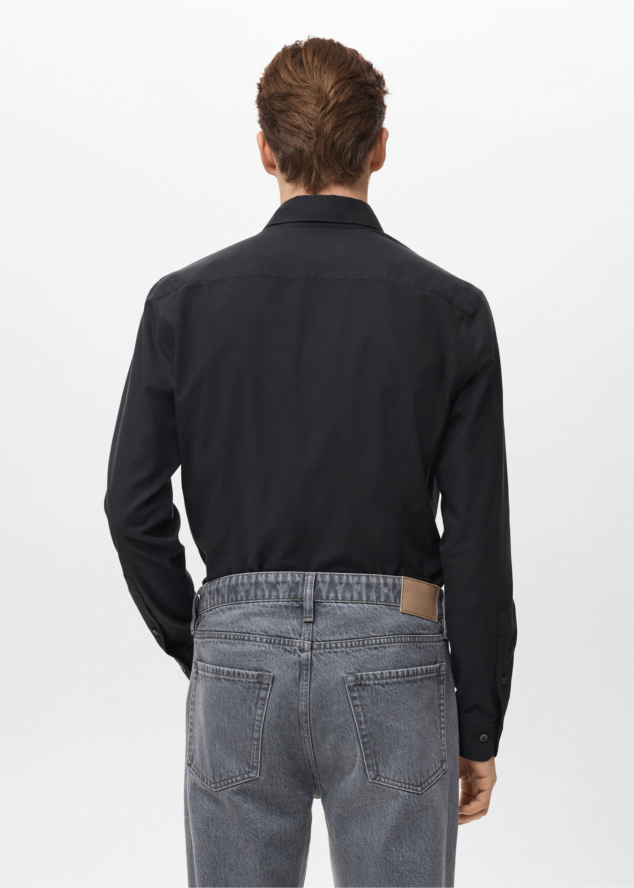 Black long-sleeved shirt seen from the back, worn with grey trousers., Black. Ref: 27081310-00.