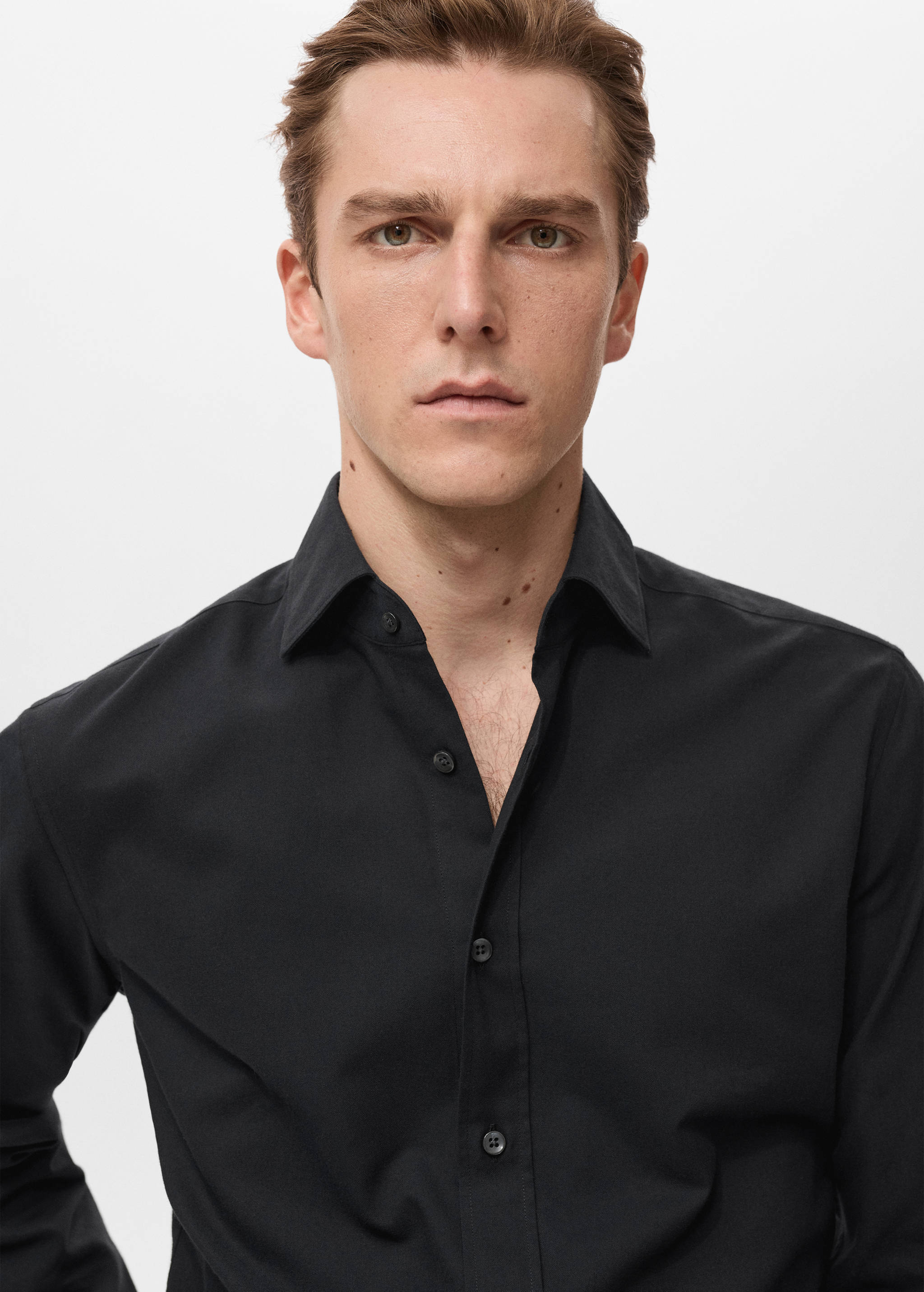 Close-up of a black shirt with a classic collar.