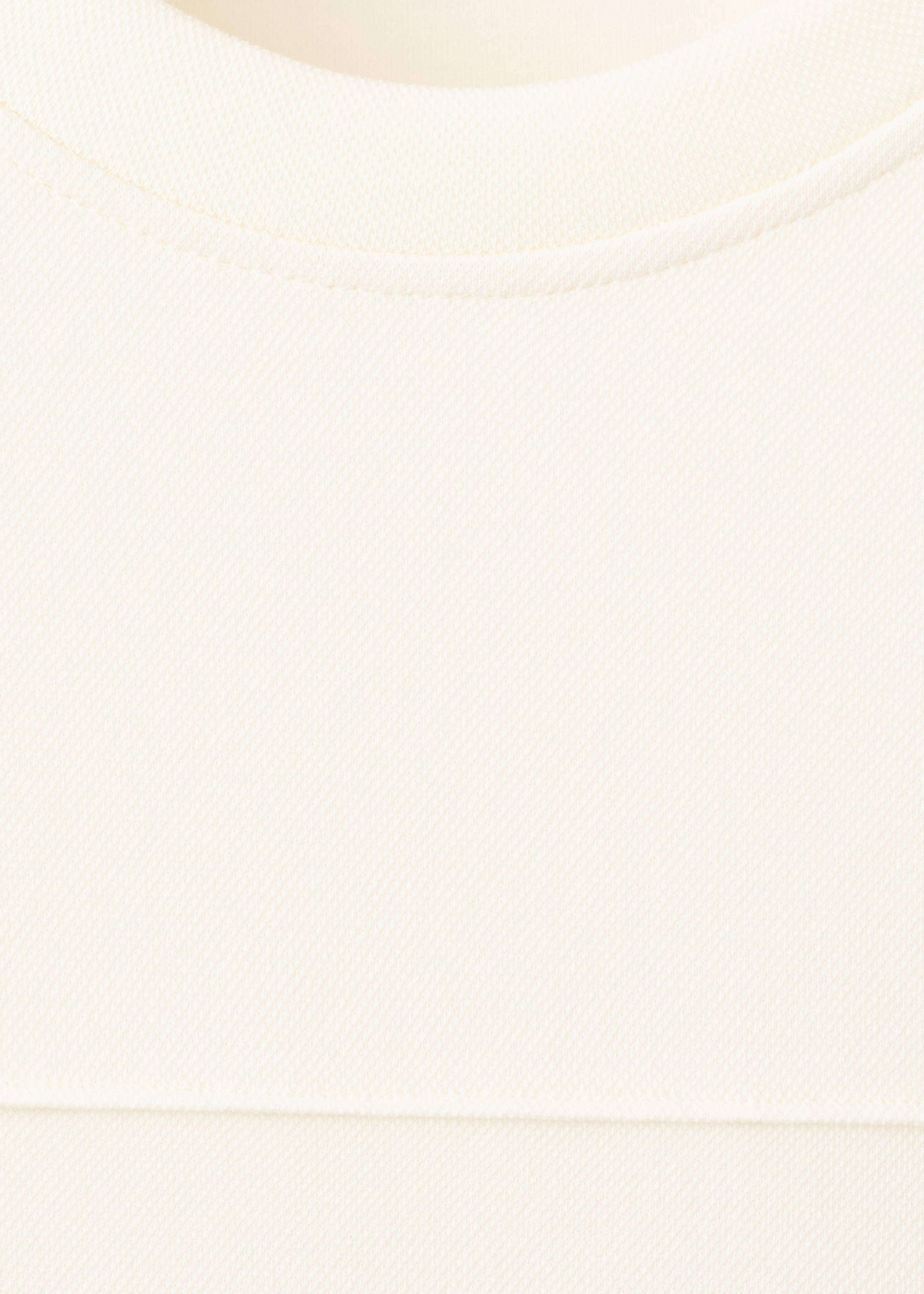 Cream sweatshirt with a round neckline and textured weave fabric.