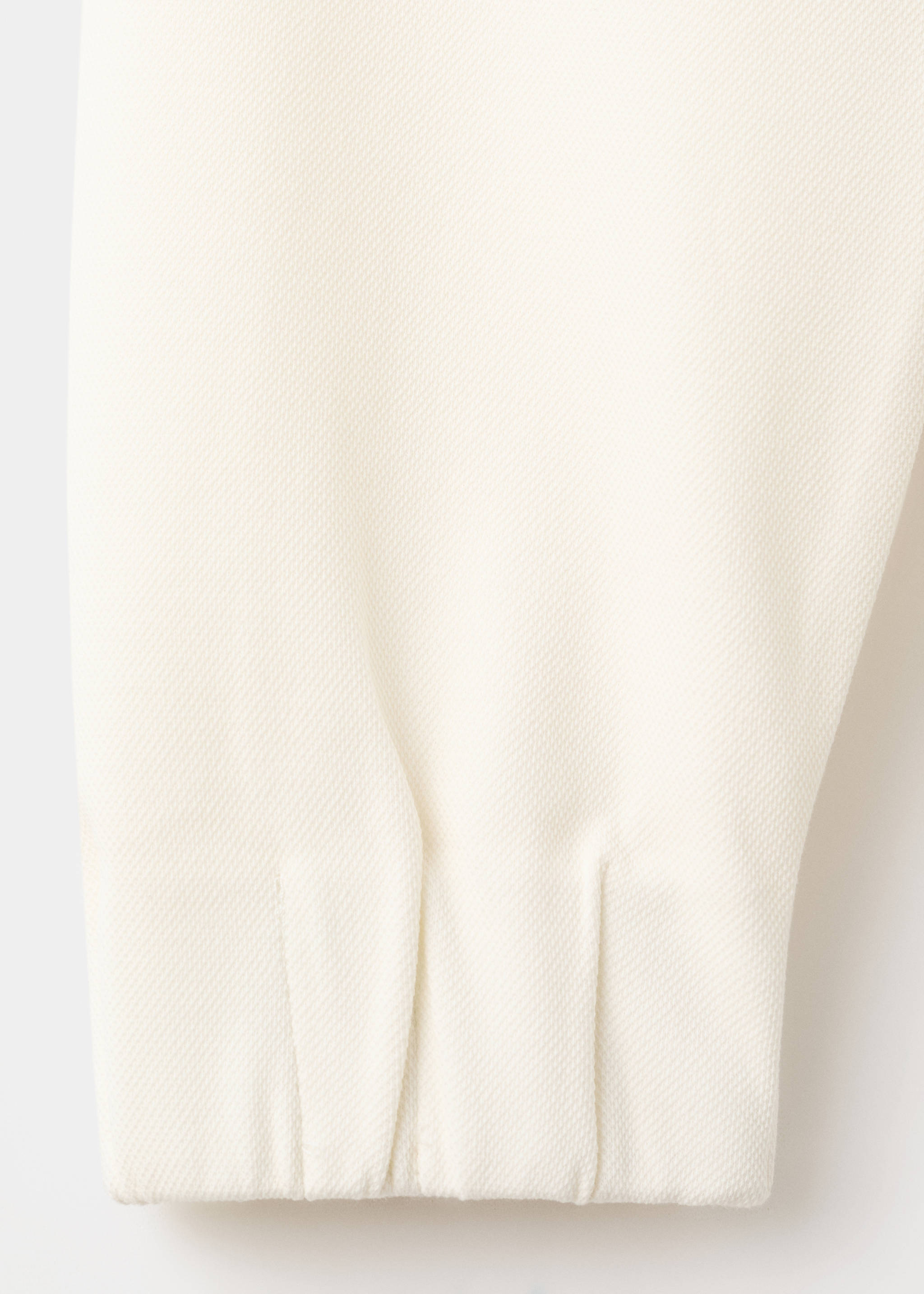 Close-up of the white sweatshirt fabric showing its textured weave.