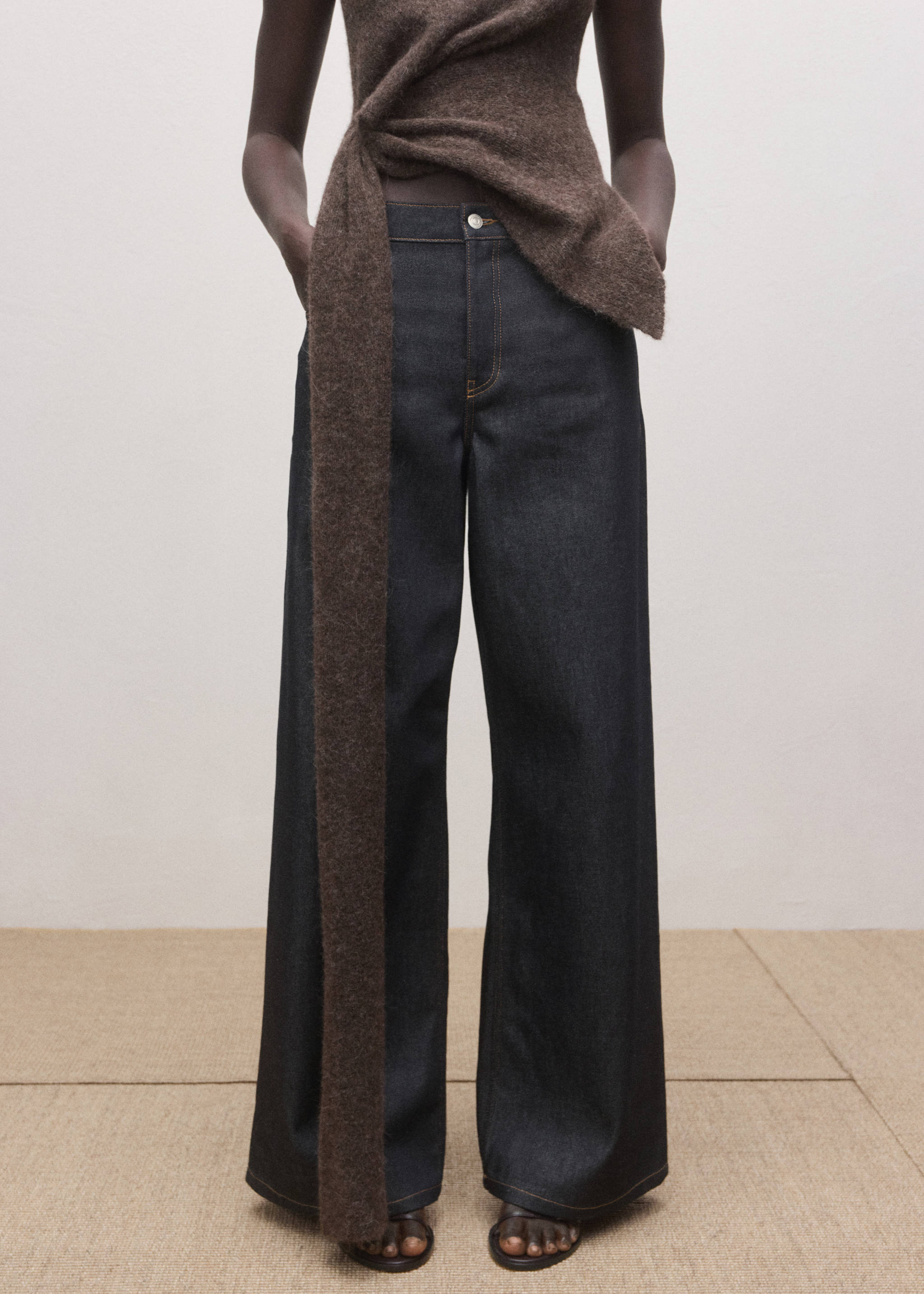 Dark blue high-waisted wide-leg denim trousers styled with a brown draped top., Open Blue. Ref: 27084445-00.