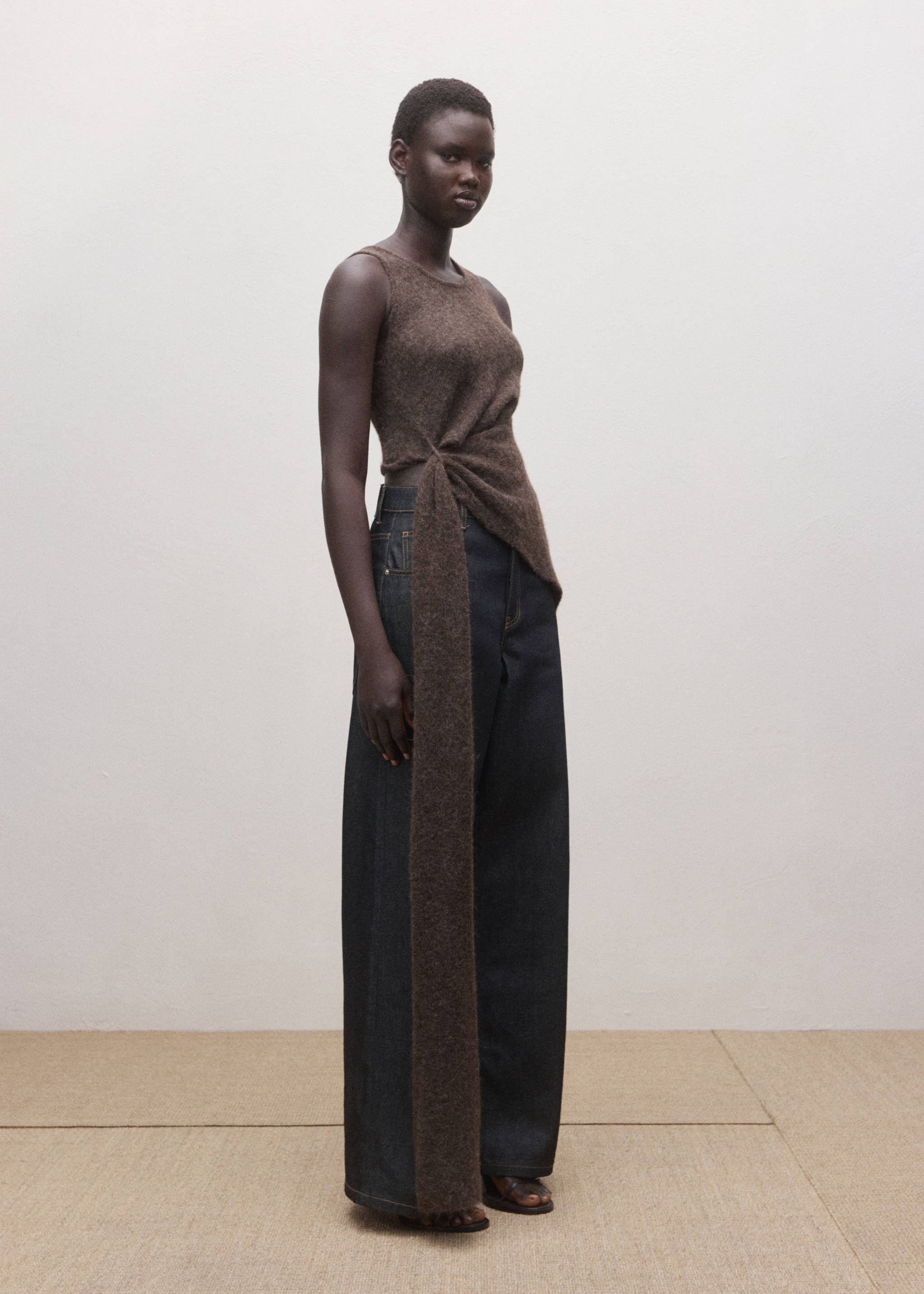 Dark brown sleeveless knitted top with a side knot and long sash, paired with wide-leg trousers., Open Blue. Ref: 27084445-00.