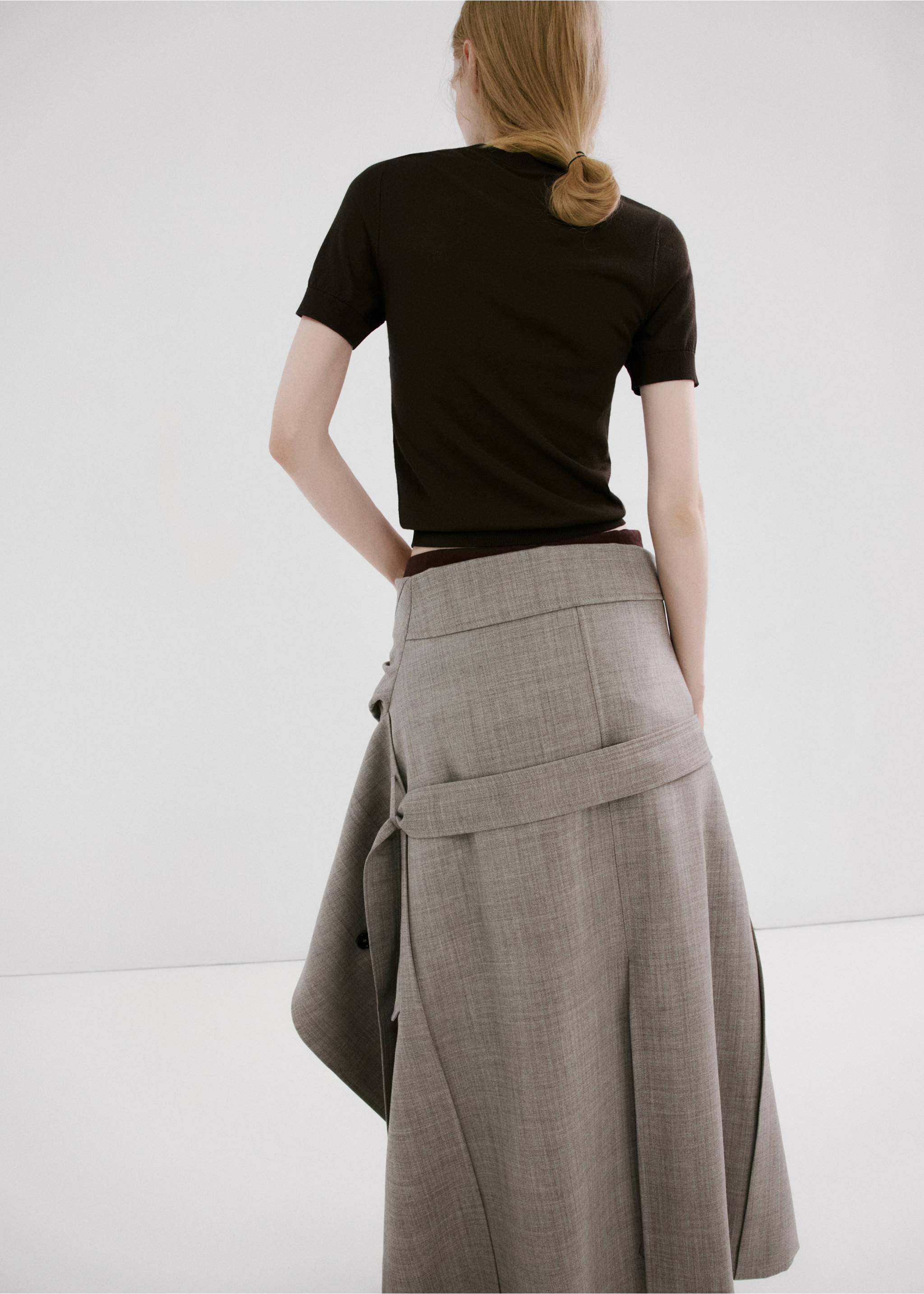 Back view of a dark brown short-sleeved knit jersey worn with a grey midi skirt., Brown. Ref: 27085838-00.