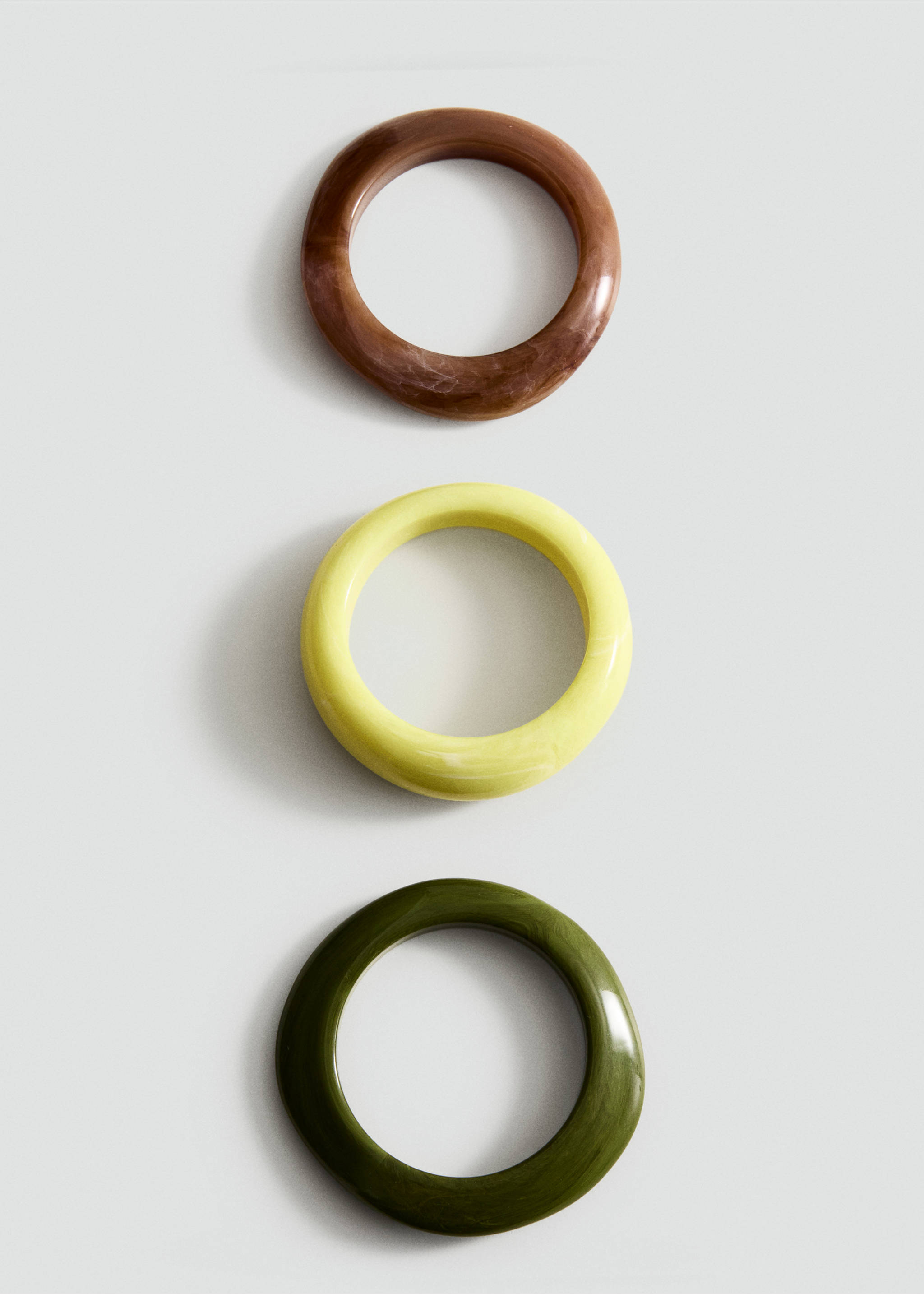 Three rigid round bracelets in marbled brown, bright yellow, and olive green., Pastel Green. Ref: 27085977-00.