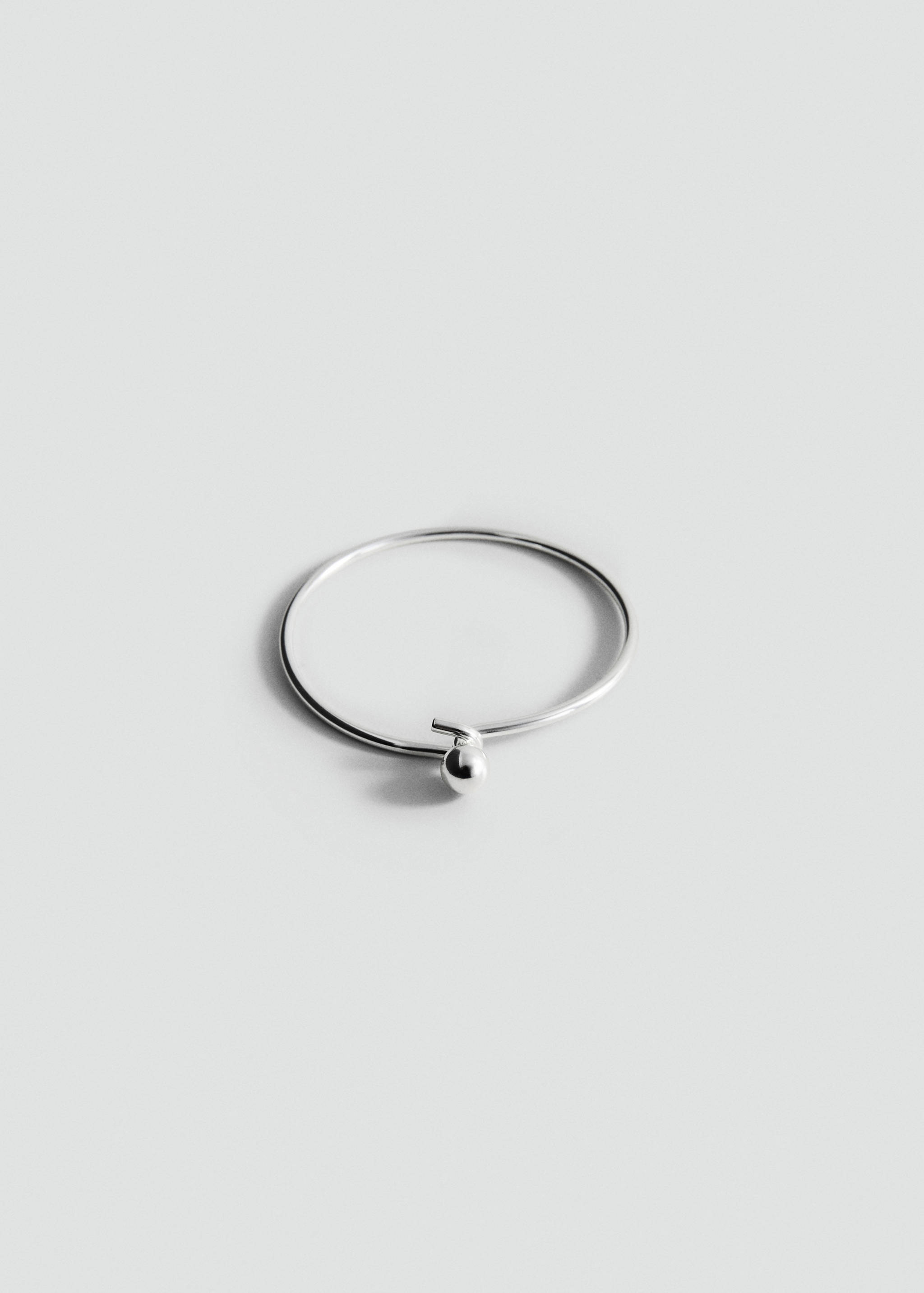Silver-coloured metal bangle bracelet with a bead detail.