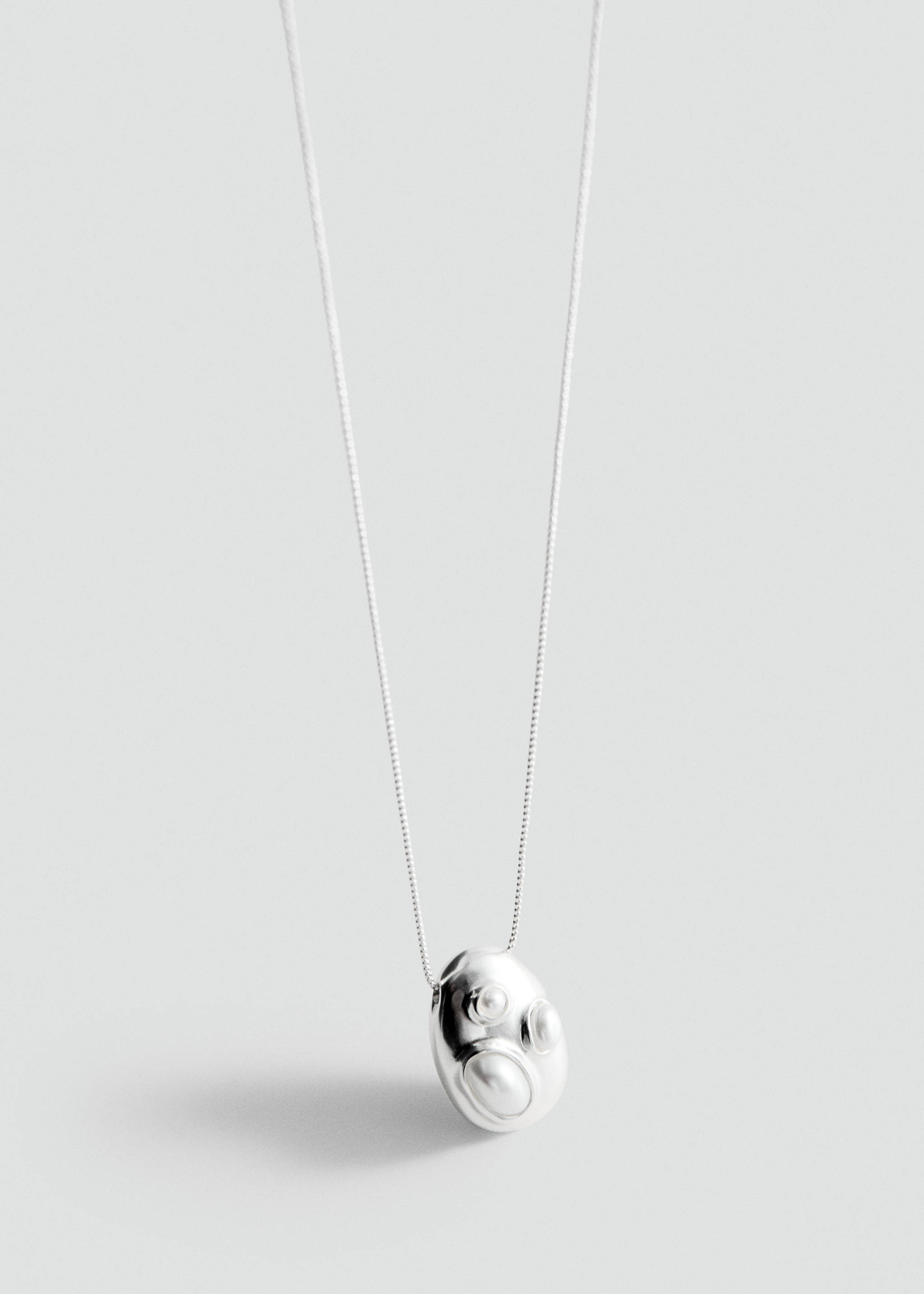 Silver-coloured necklace with an organic pebble-shaped pendant.