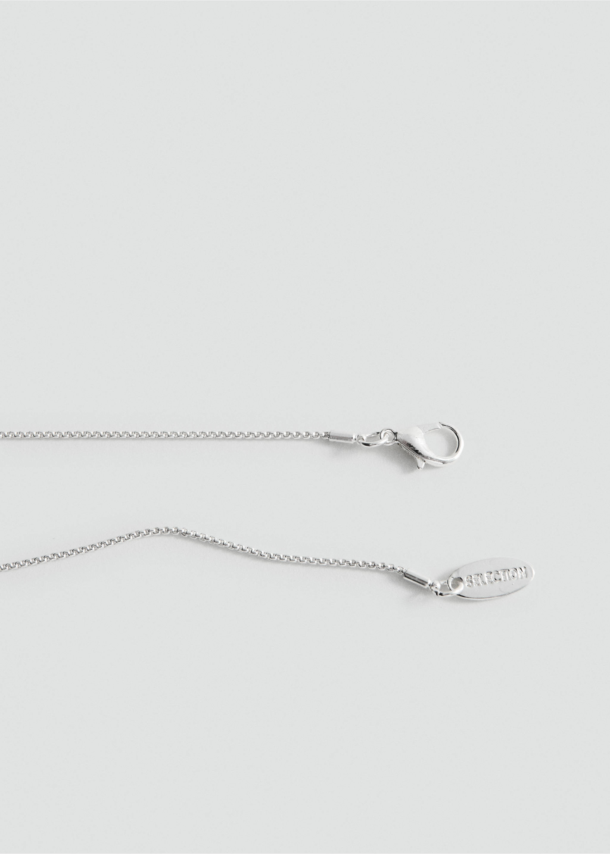 Close-up of a silver-toned necklace clasp and chain., Silver. Ref: 27087796-00.