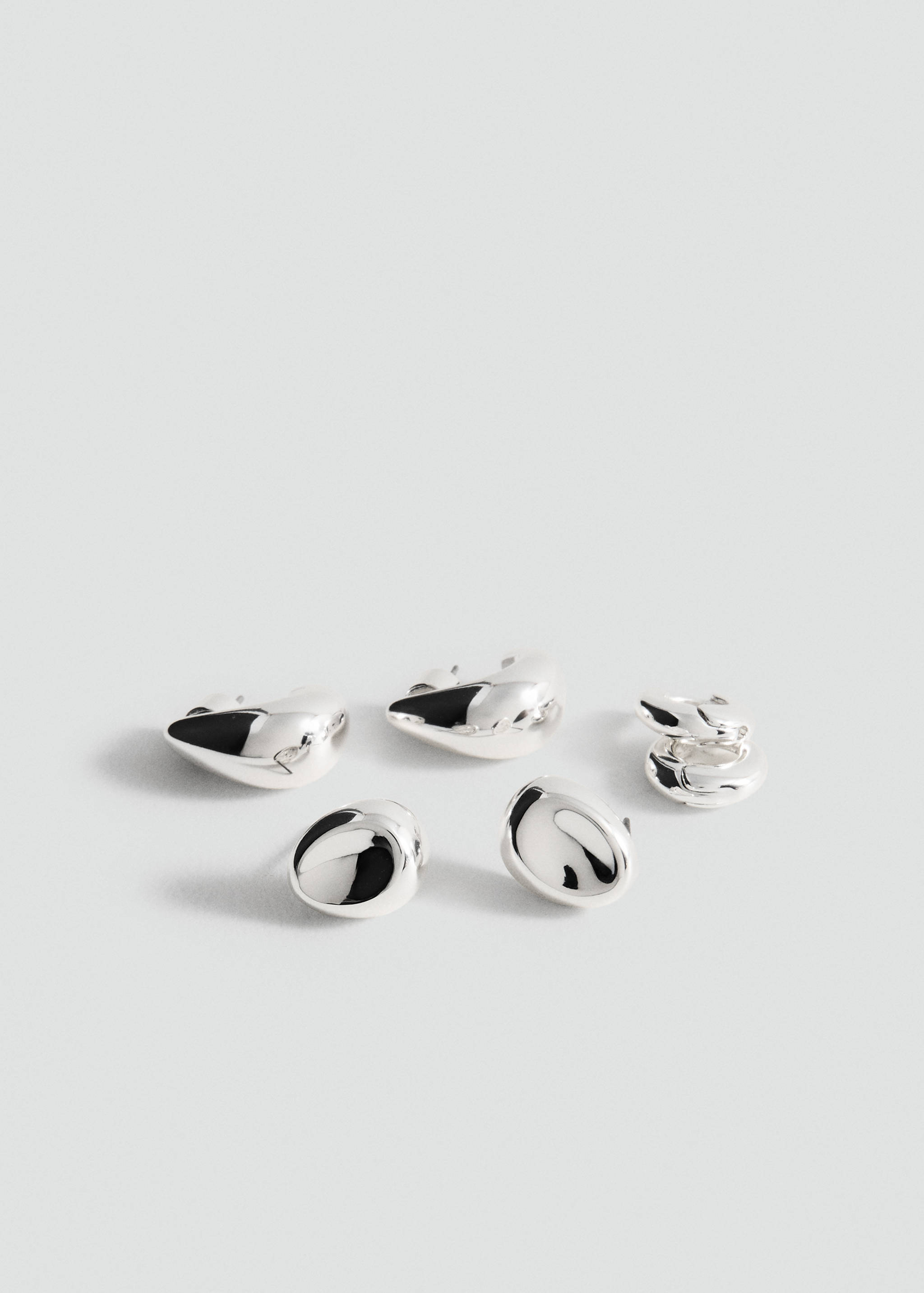 Silver-finish metal earrings with glossy, organic shapes.