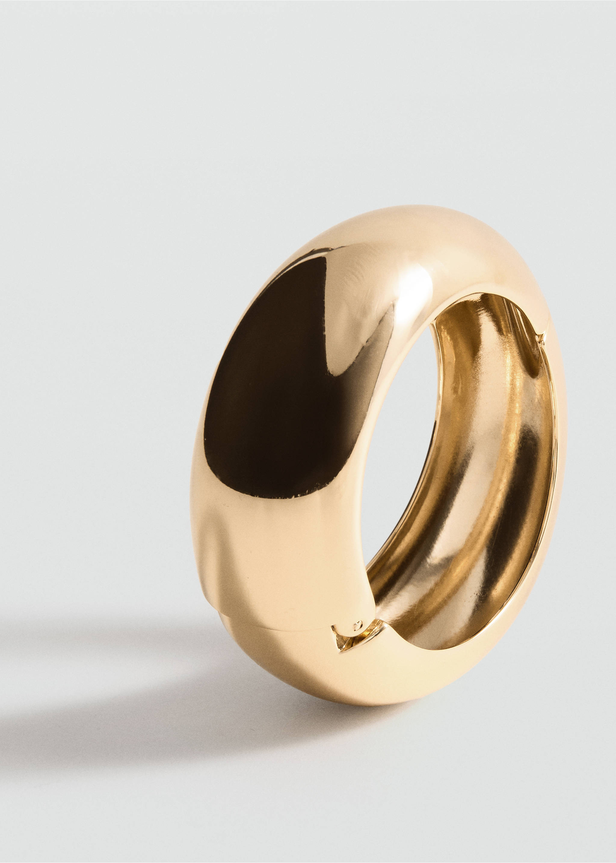 Chunky gold-tone metal bracelet with a smooth, curved profile., Gold. Ref: 27091284-00.