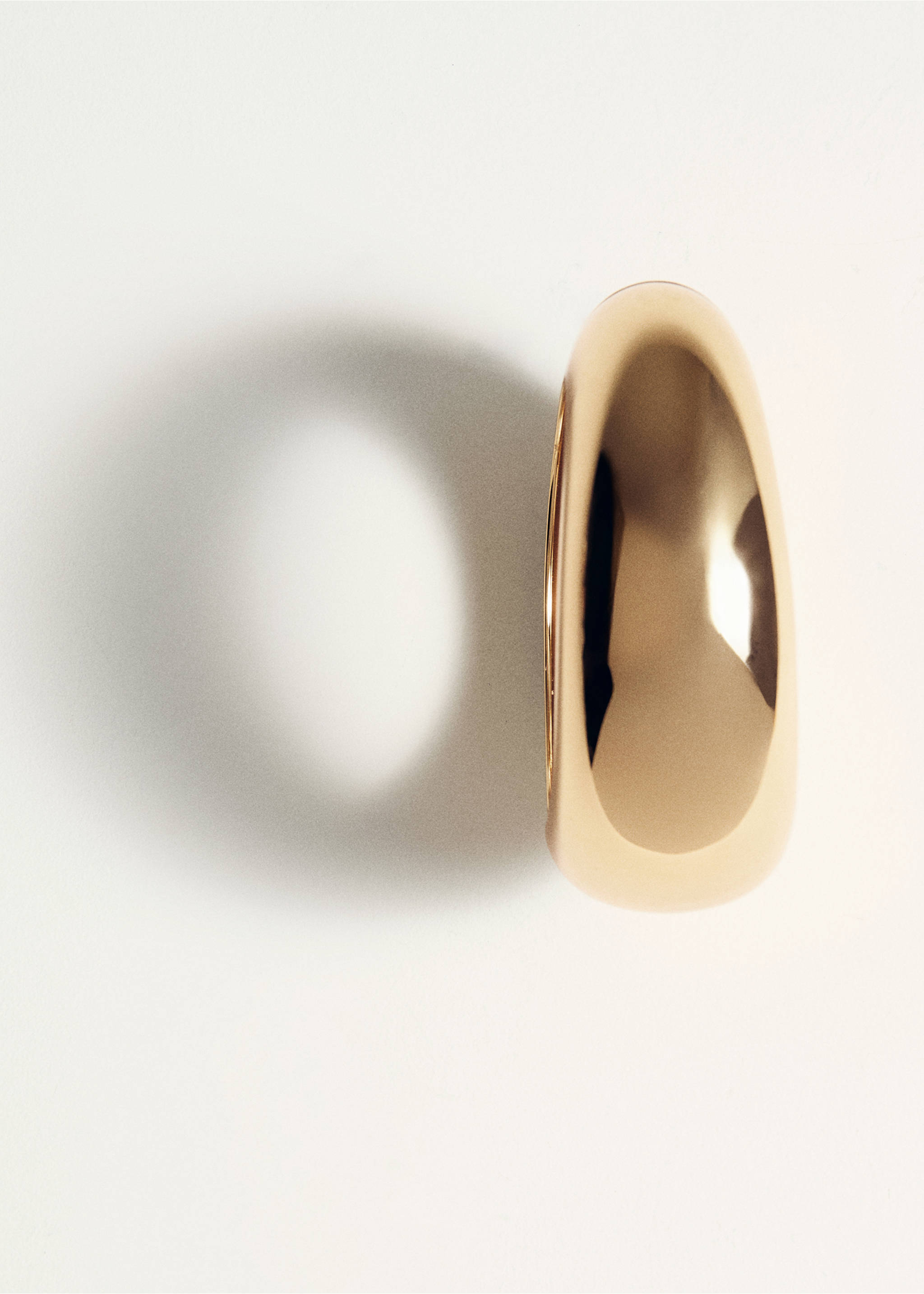Chunky gold-tone bracelet in a close-up studio shot., Gold. Ref: 27091284-00.