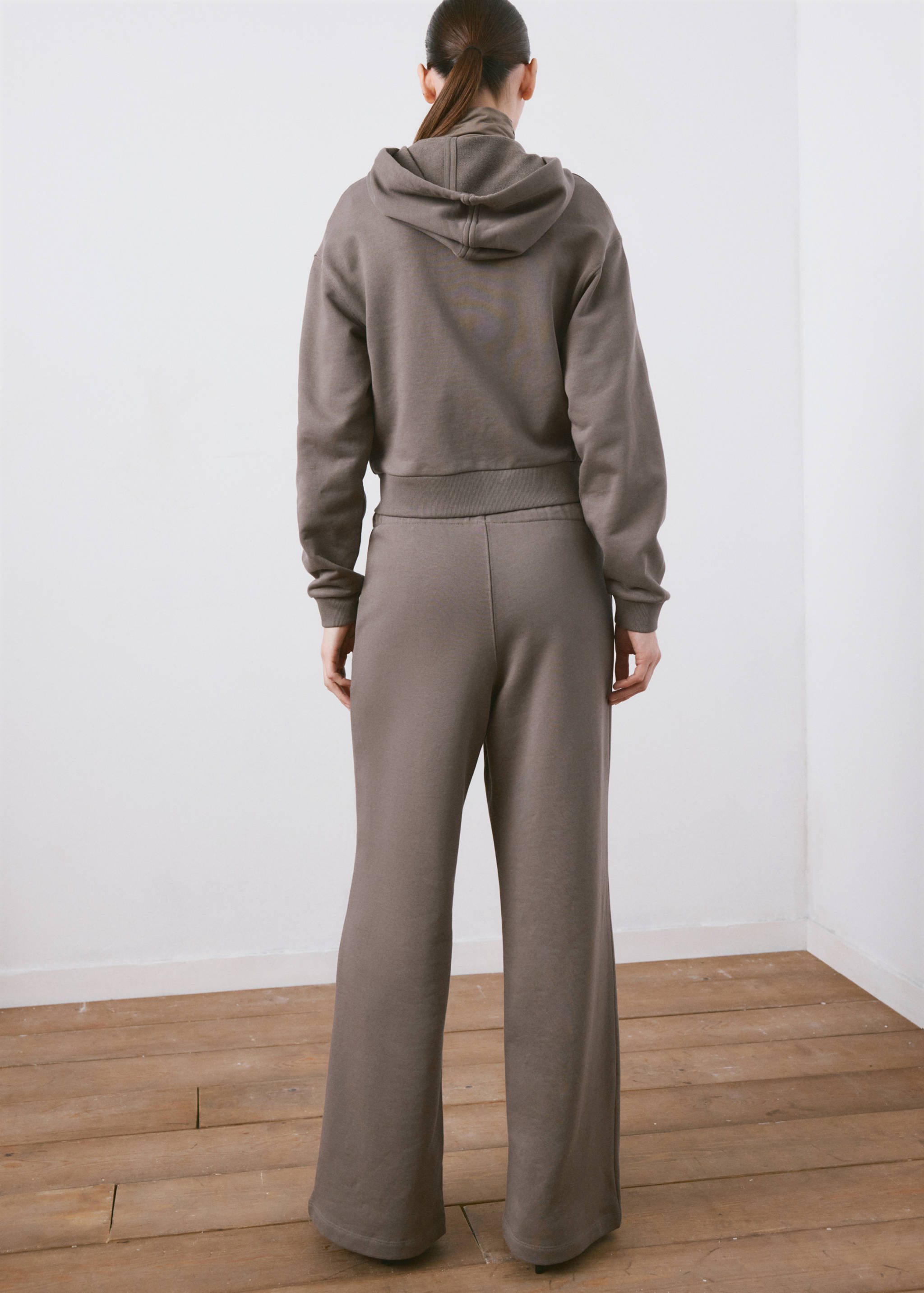 Taupe hooded sweatshirt, back view.