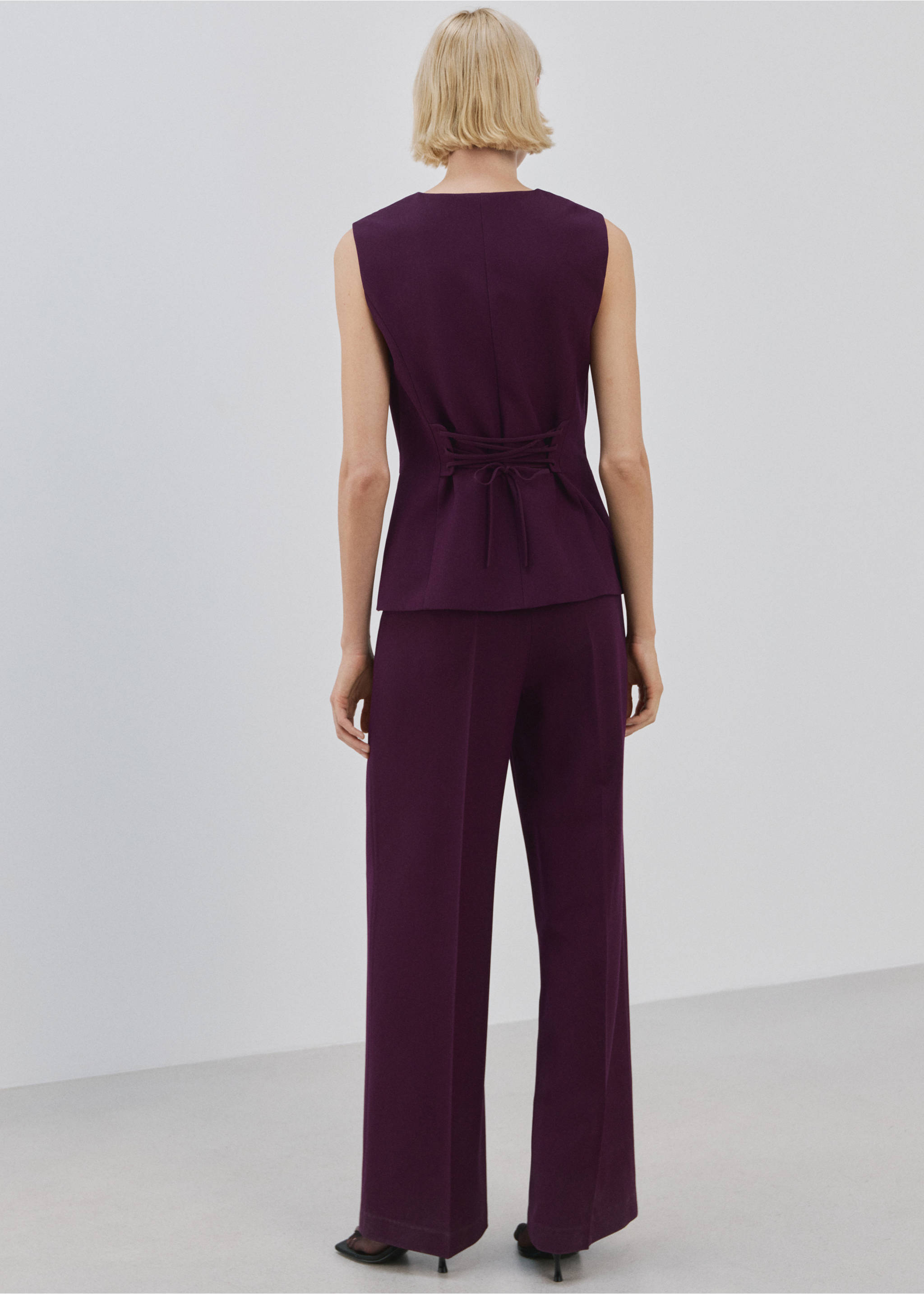 Dark purple sleeveless jumpsuit with a laced back, shown from the back., Plum. Ref: 27094084-00.