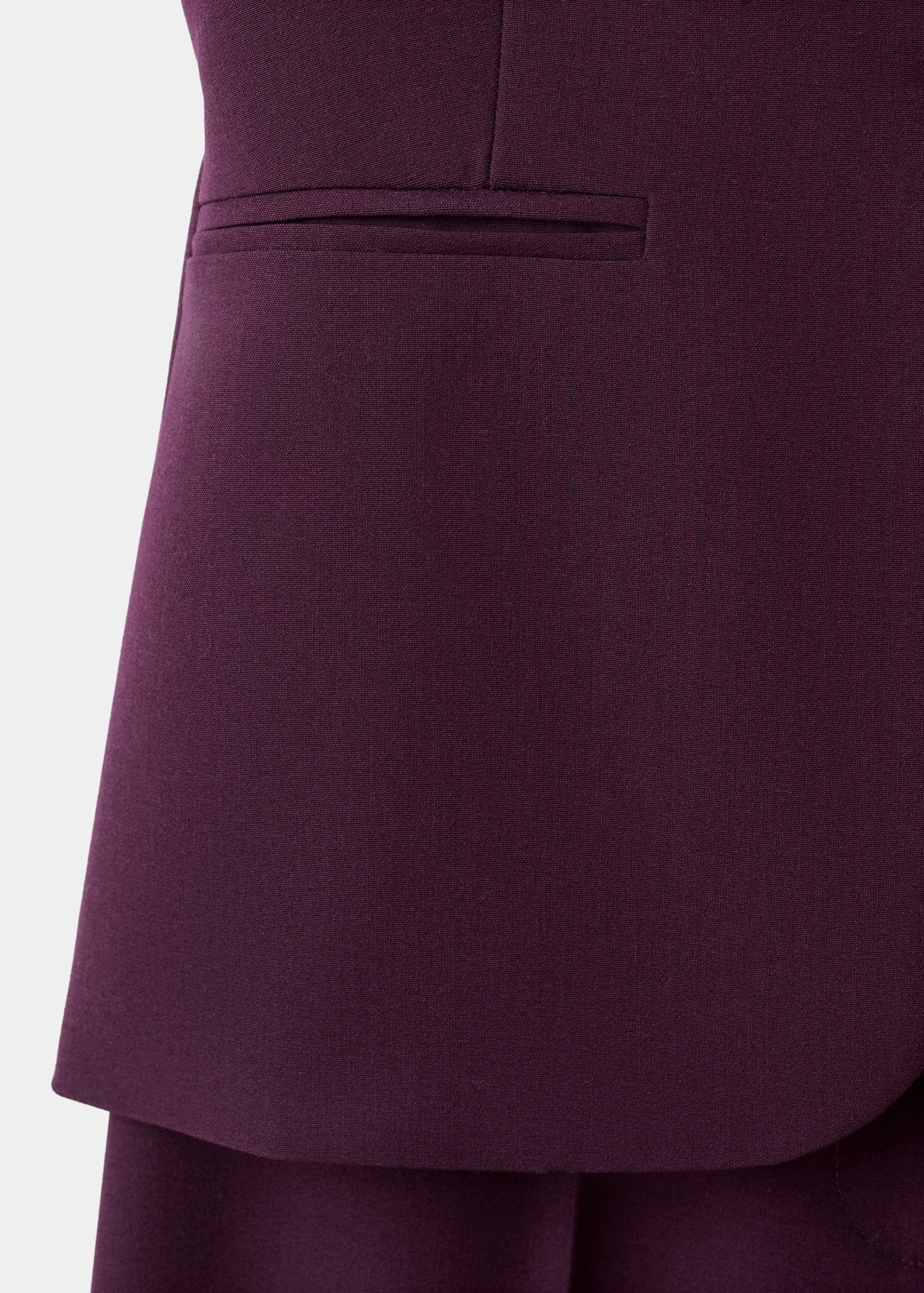 Deep plum purple jumpsuit bodice detail with a welt pocket.