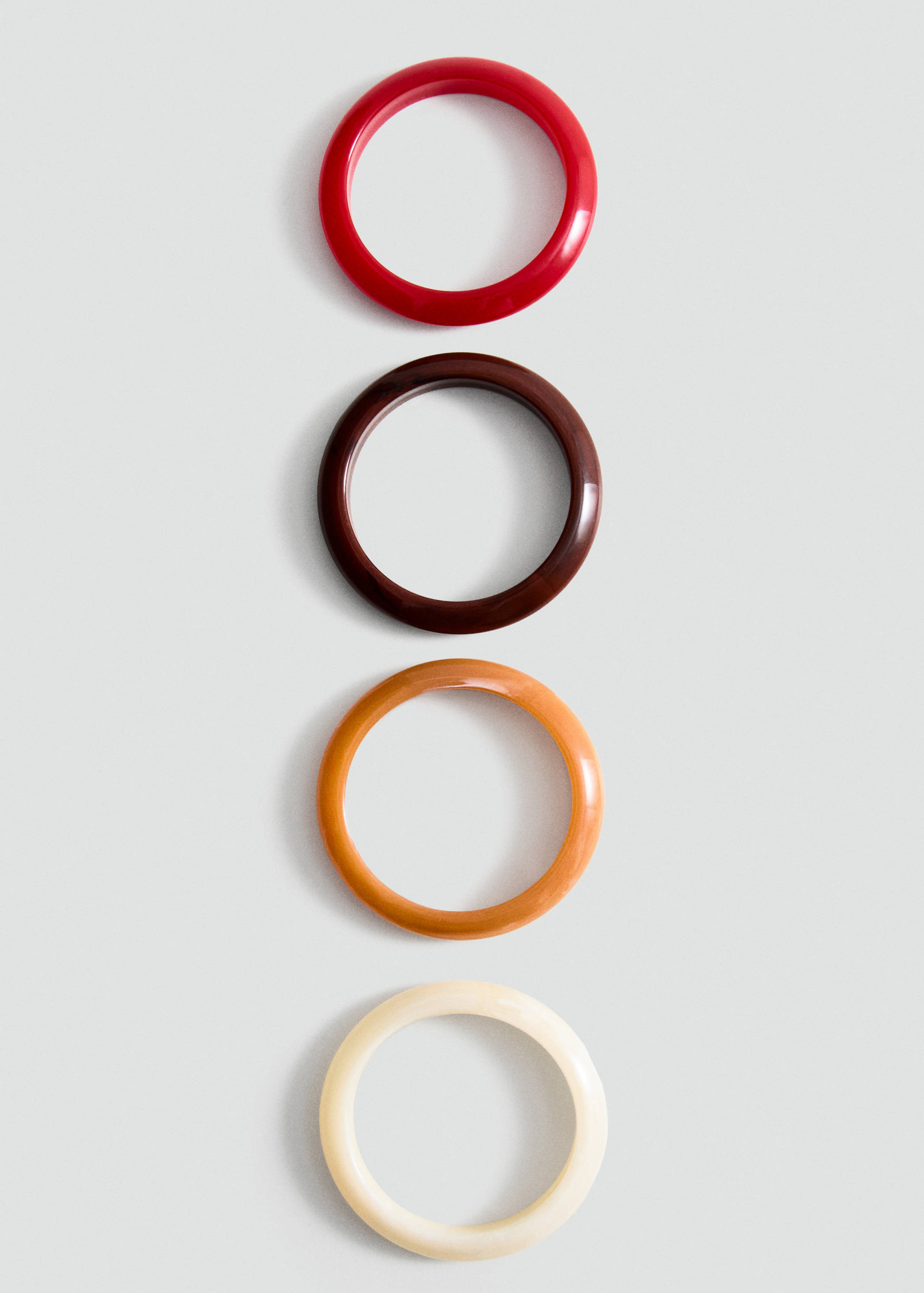 Set of four rigid bangles in red, dark brown, orange, and off-white.