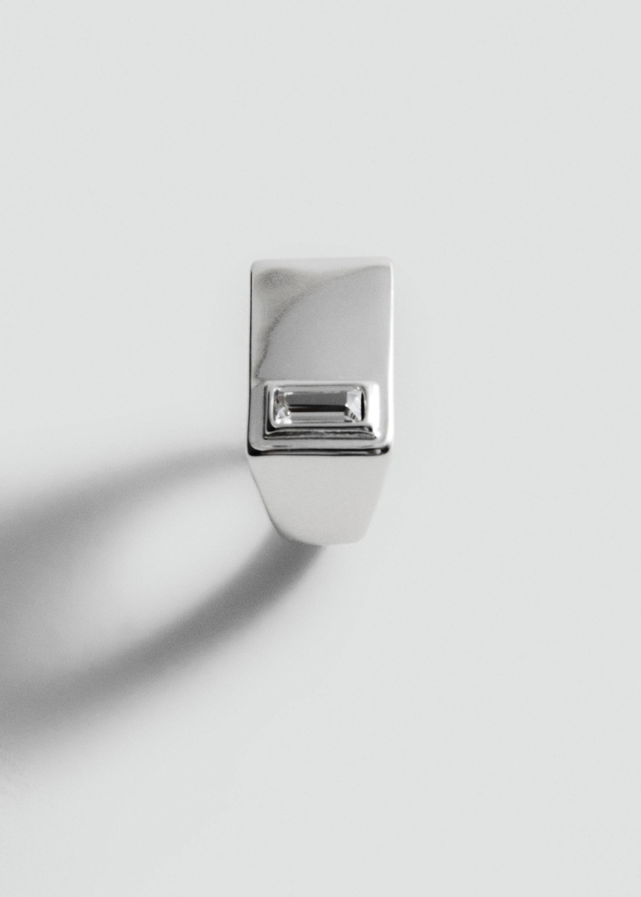 Silver-coloured signet ring with a central baguette crystal.