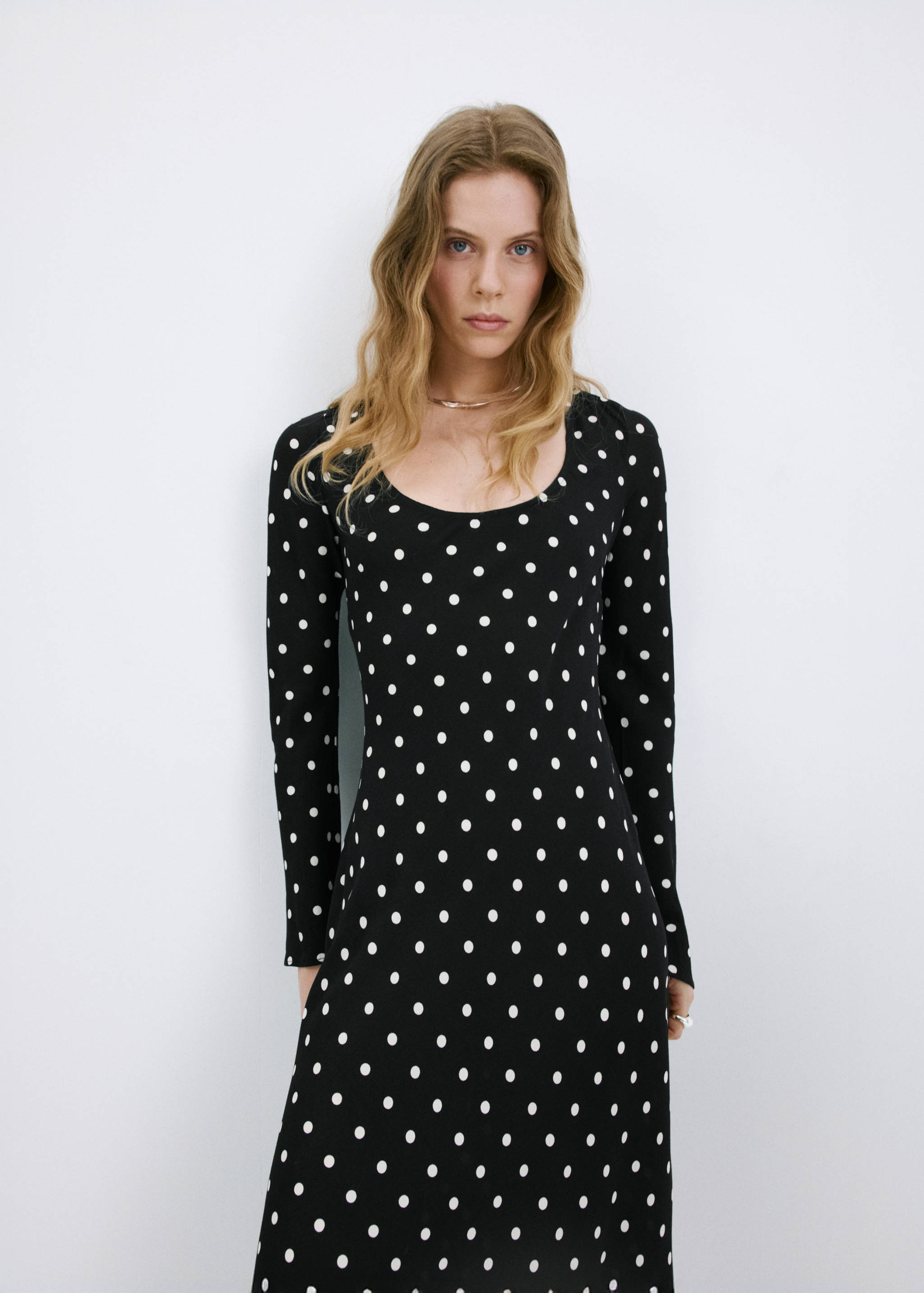 Black and white polka dot long-sleeved midi dress with scoop neck