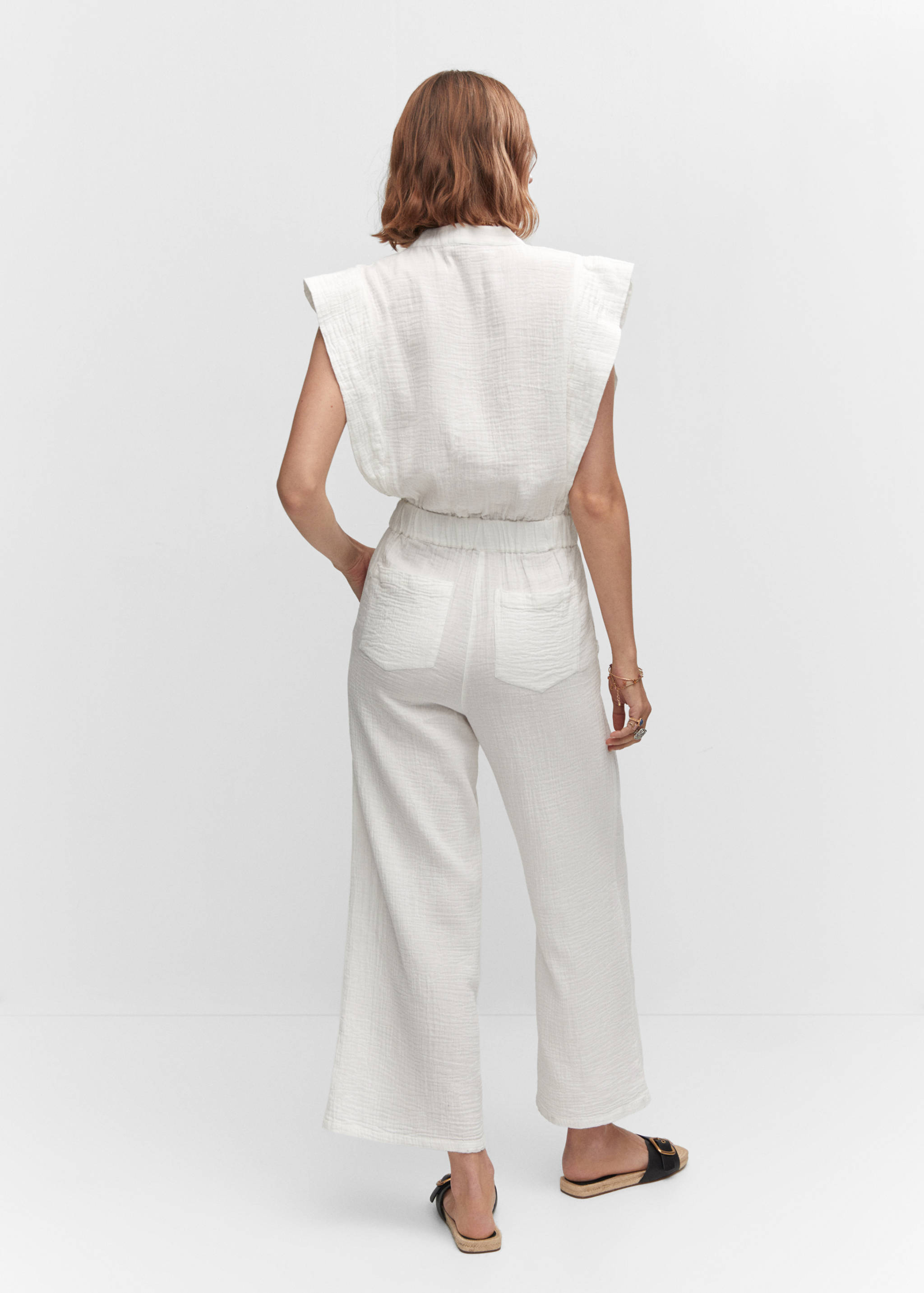 Textured jumpsuit with button - Details of the article 1