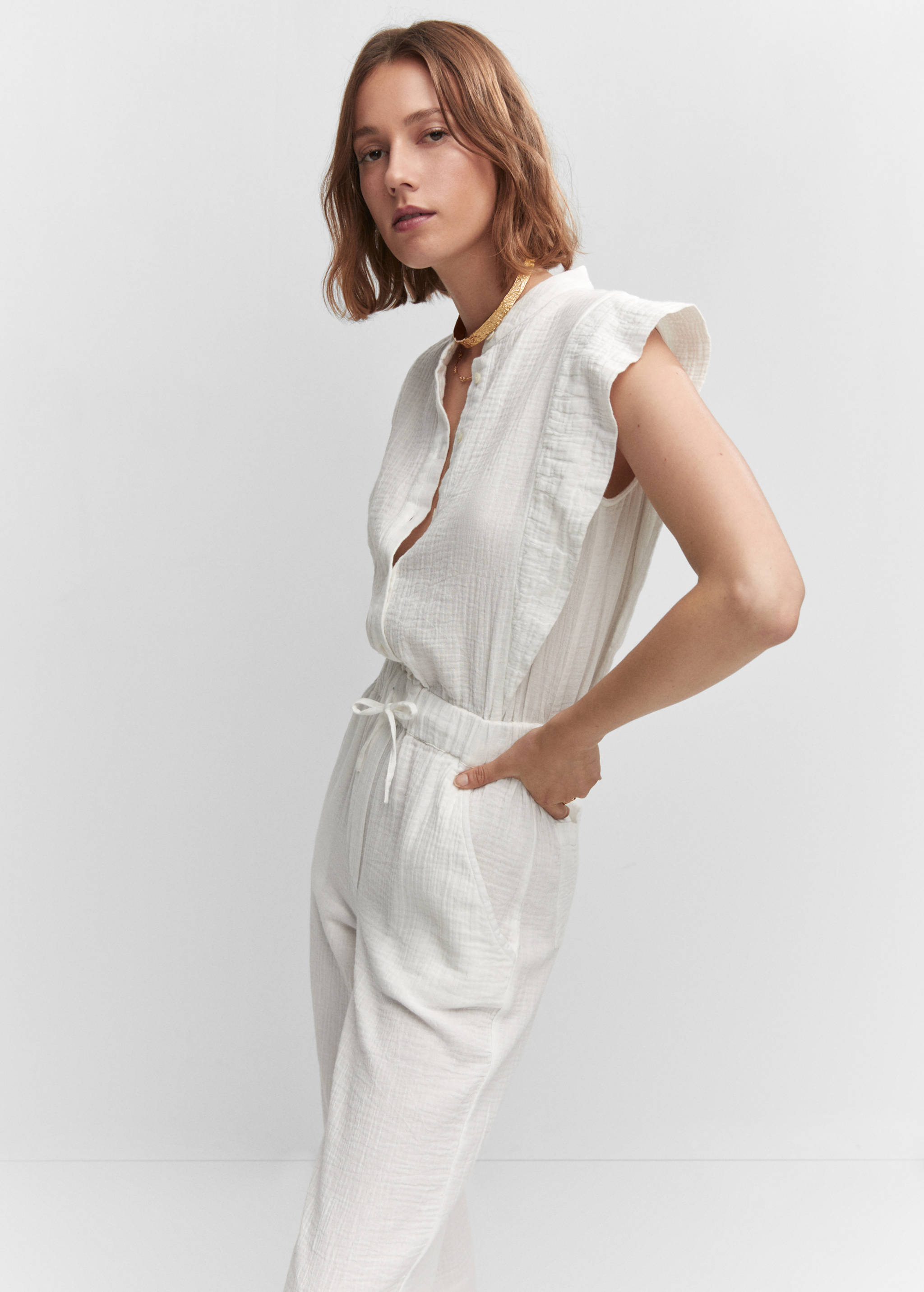 Textured jumpsuit with button - Details of the article 6