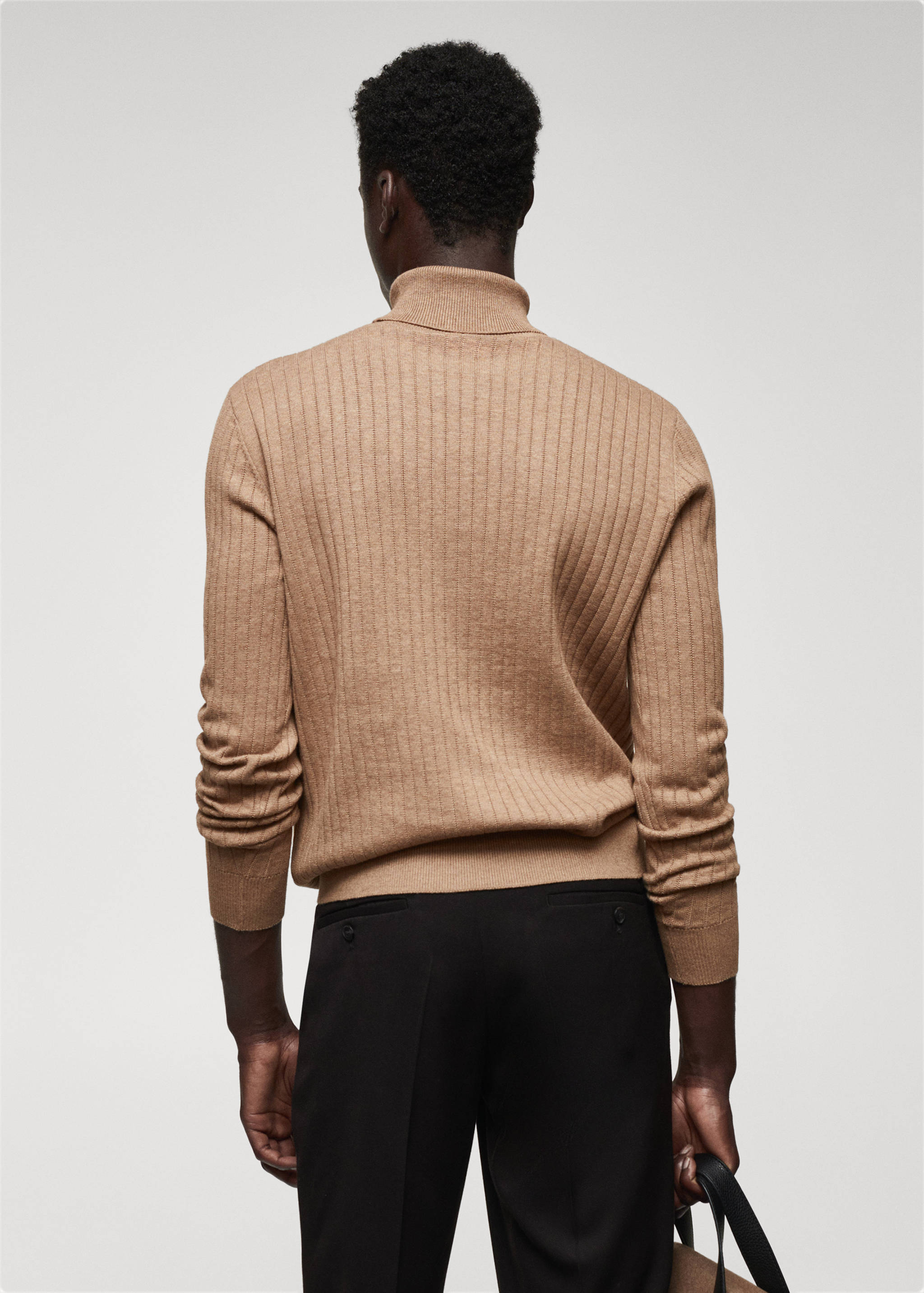 Rolled neck cable sweater - Reverse of the article