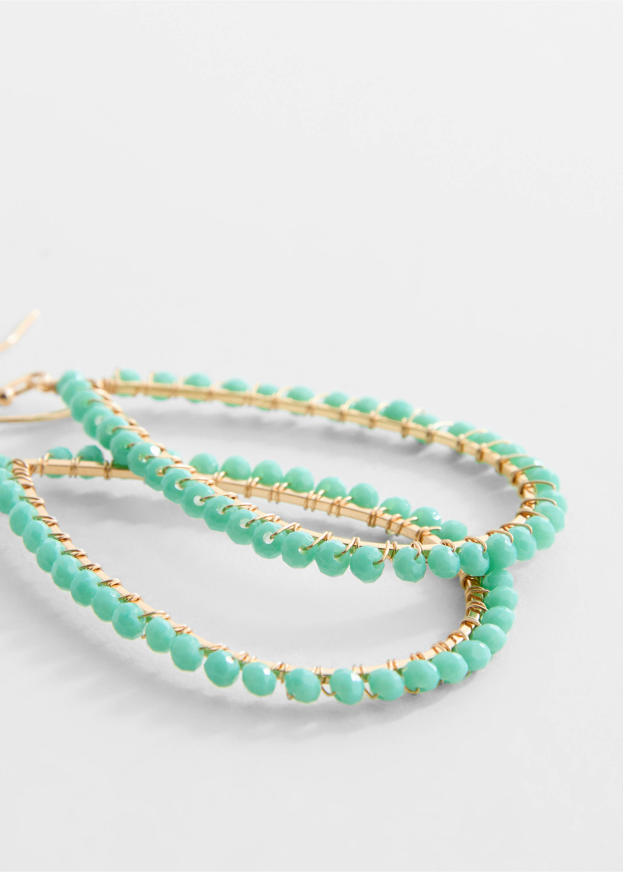 Owalne kolczyki z koralikami - Plan średni, Turkusowy. Ref: 77000272-00.